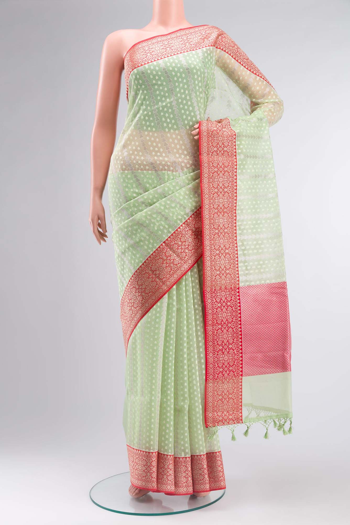 Green Blended Kora Cotton Saree with Zari Butta on the body and Zari Border.  displayed on a mannequin