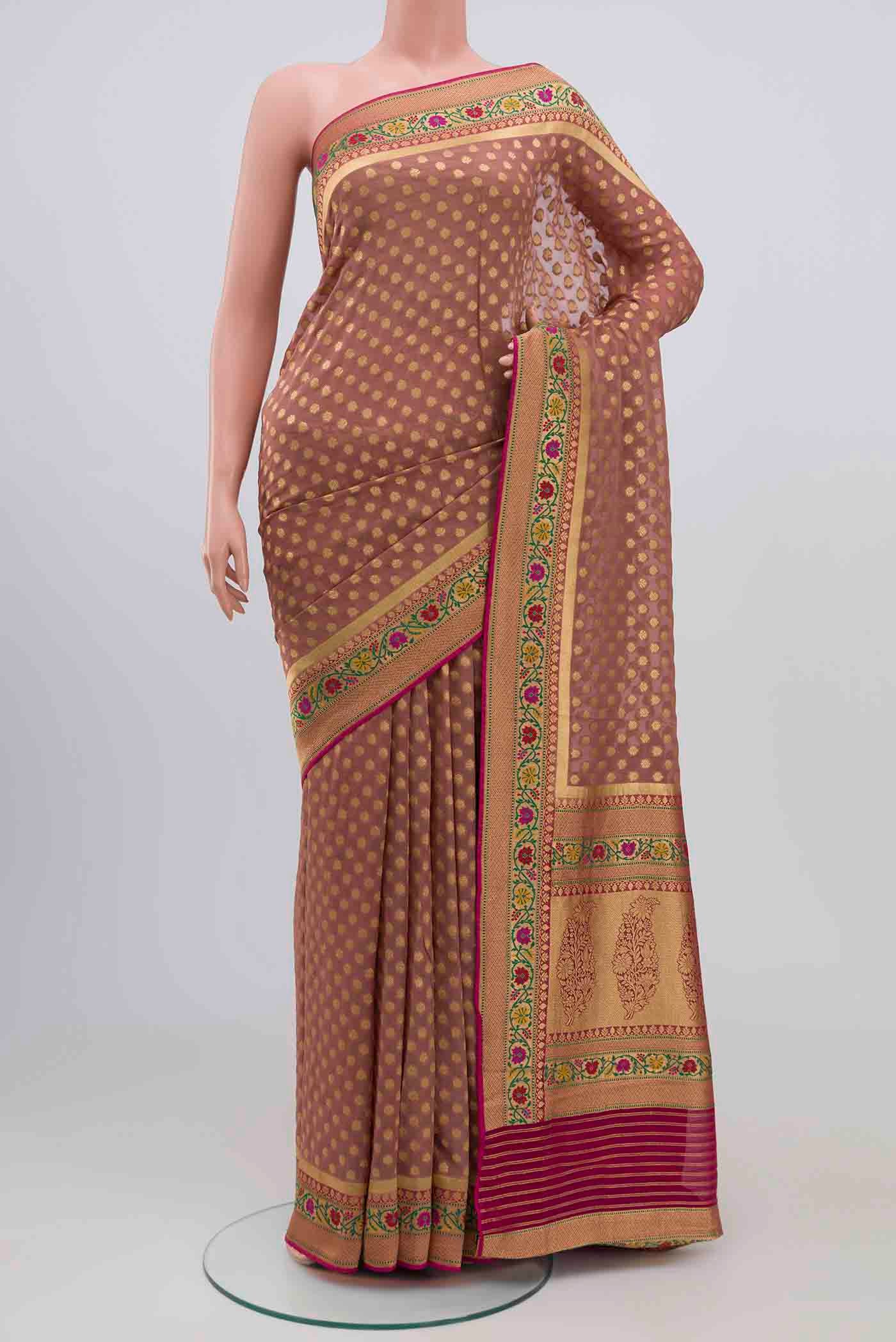 Mauve Banarasi Georgette Saree with Zari Butta on the body and Zari Border.  displayed on a mannequin