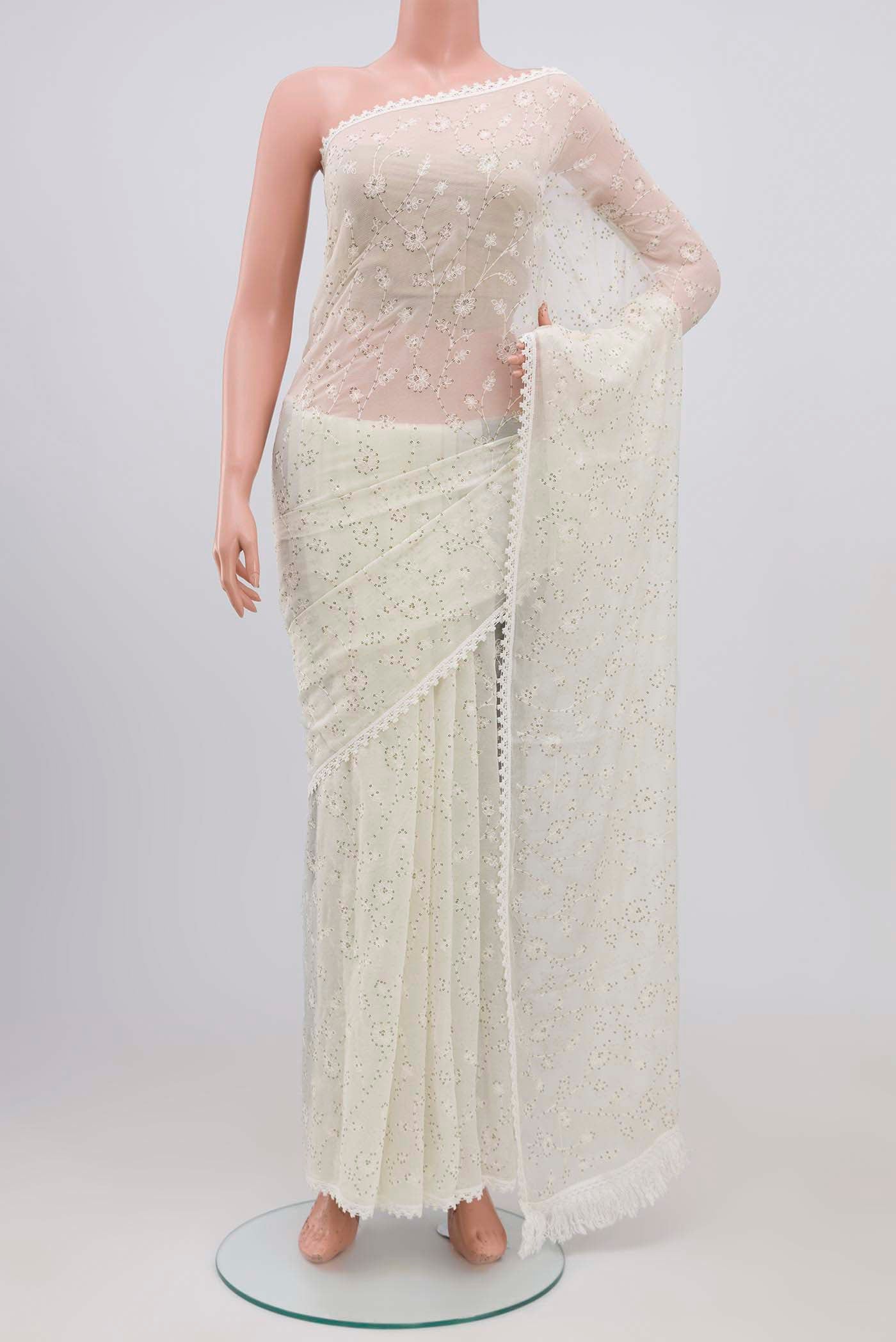 Off White Blended Chiffon Saree with Embroidery on the body and Lace Border.  displayed on a mannequin