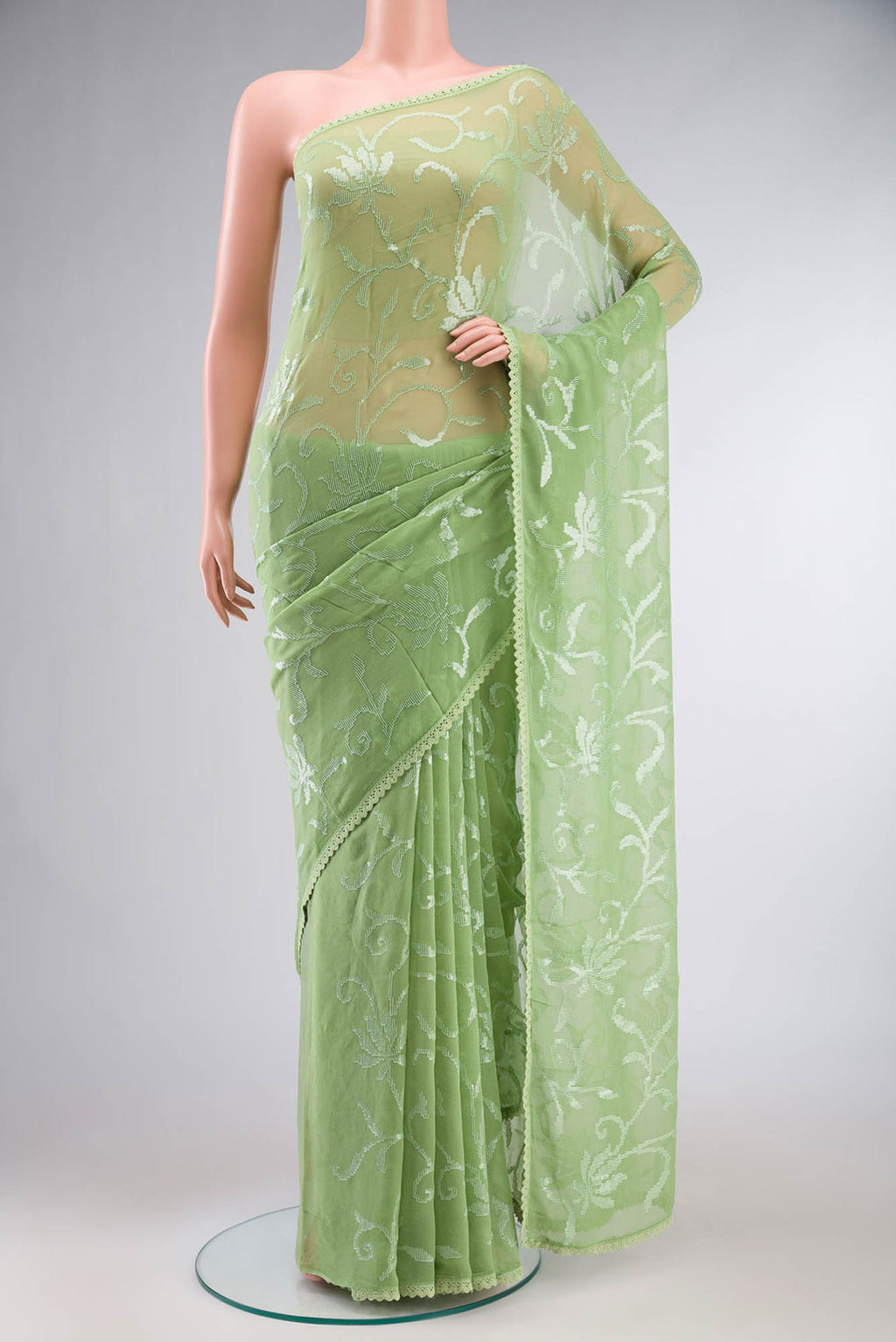 Green Blended Chiffon Saree with Embroidery on the body and Lace Border.  displayed on a mannequin