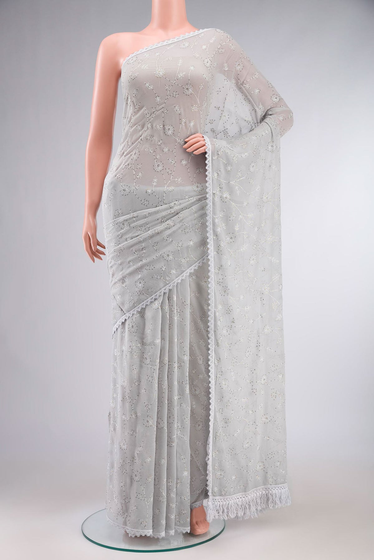 Grey Blended Chiffon Saree with Embroidery on the body and Lace Border.  displayed on a mannequin