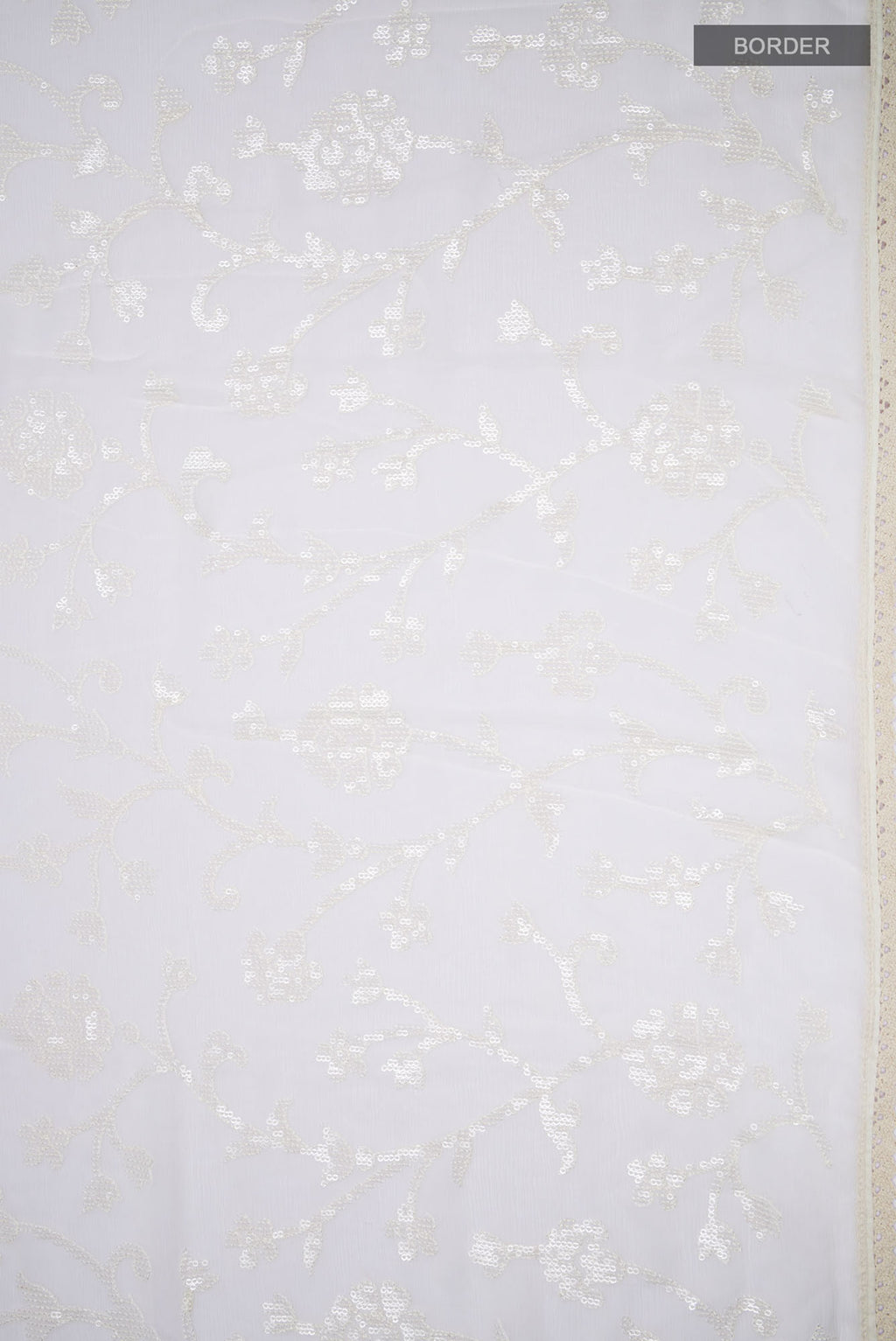 Border image of Cream Blended Chiffon Saree with Embroidery on the body and Lace Border. 