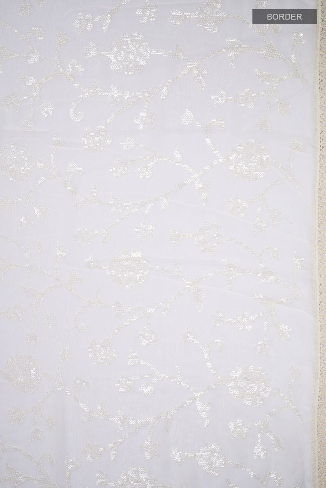 Border image of Cream Blended Chiffon Saree with Embroidery on the body and Lace Border. 