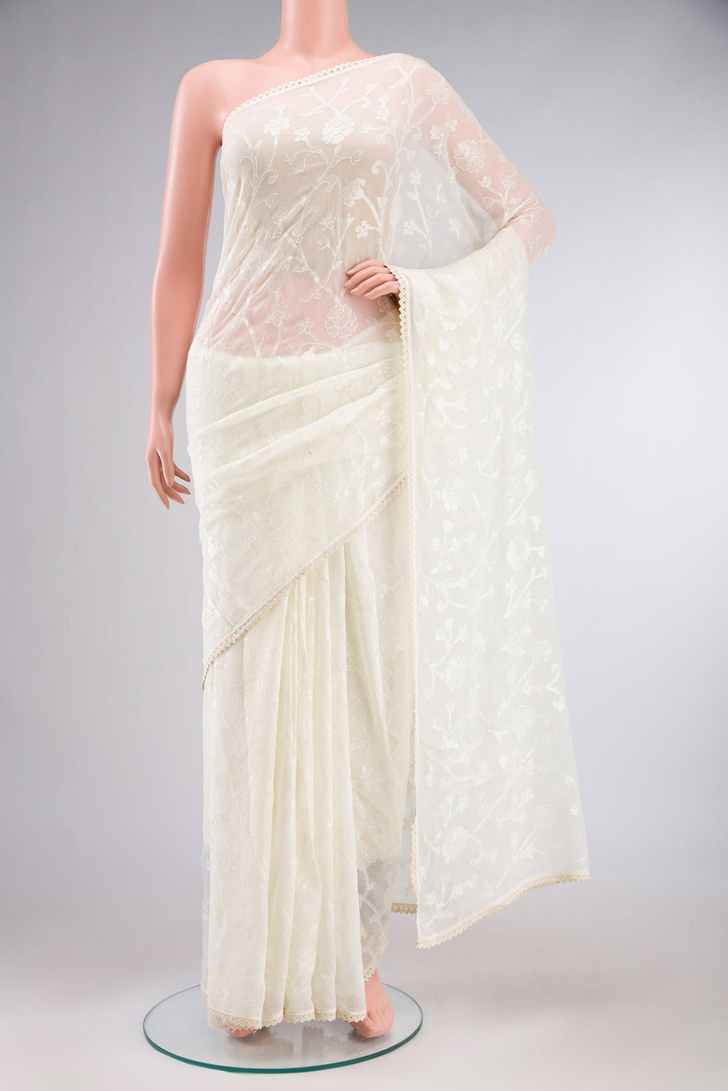 Cream Blended Chiffon Saree with Embroidery on the body and Lace Border.  displayed on a mannequin