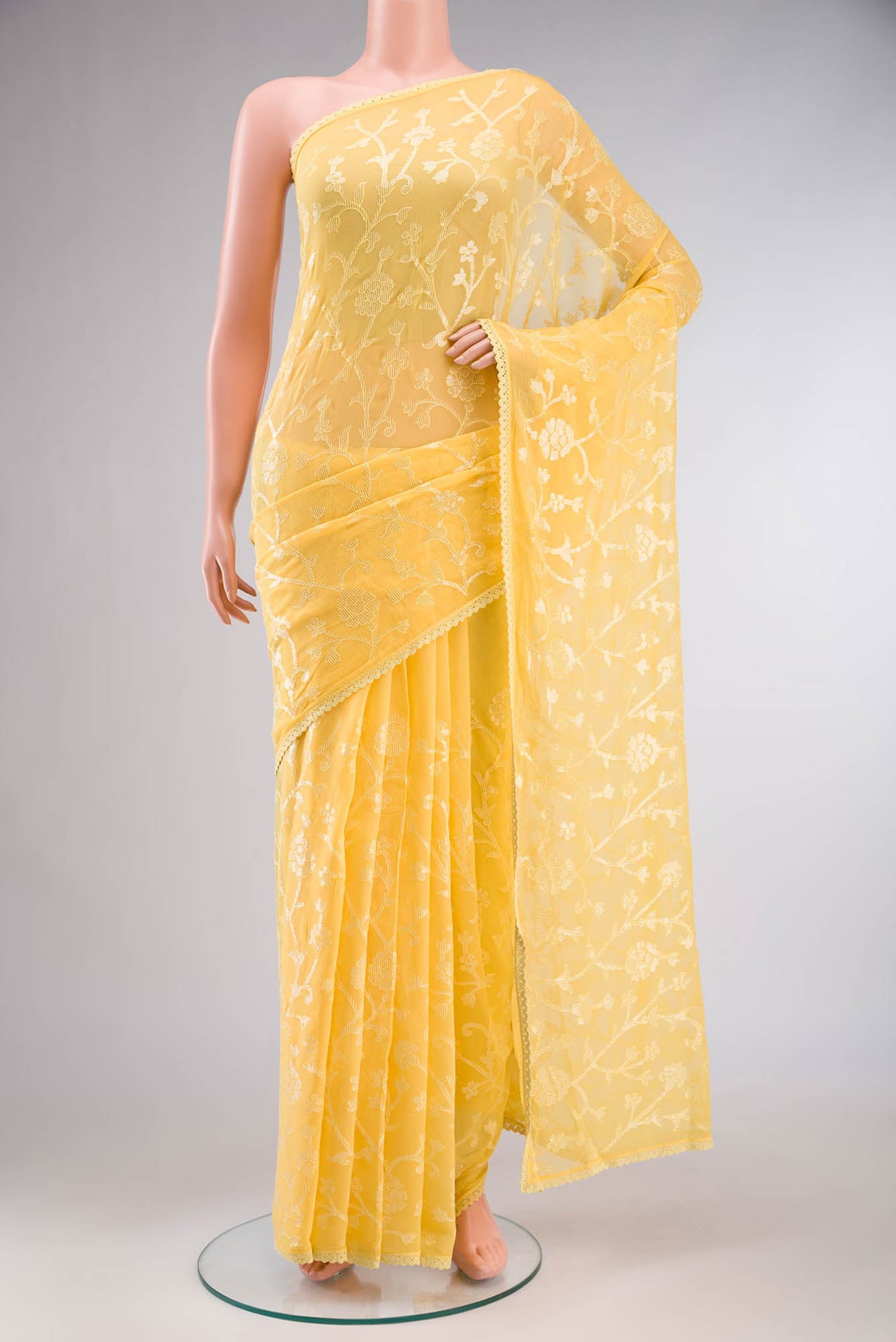 Yellow Blended Chiffon Saree with Embroidery on the body and Lace Border.  displayed on a mannequin