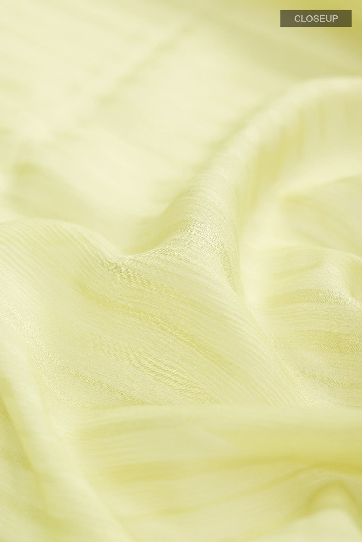Close up of Green Mysore Chiffon Saree with Stripes on the body and Embroidery Border.  displaying folds