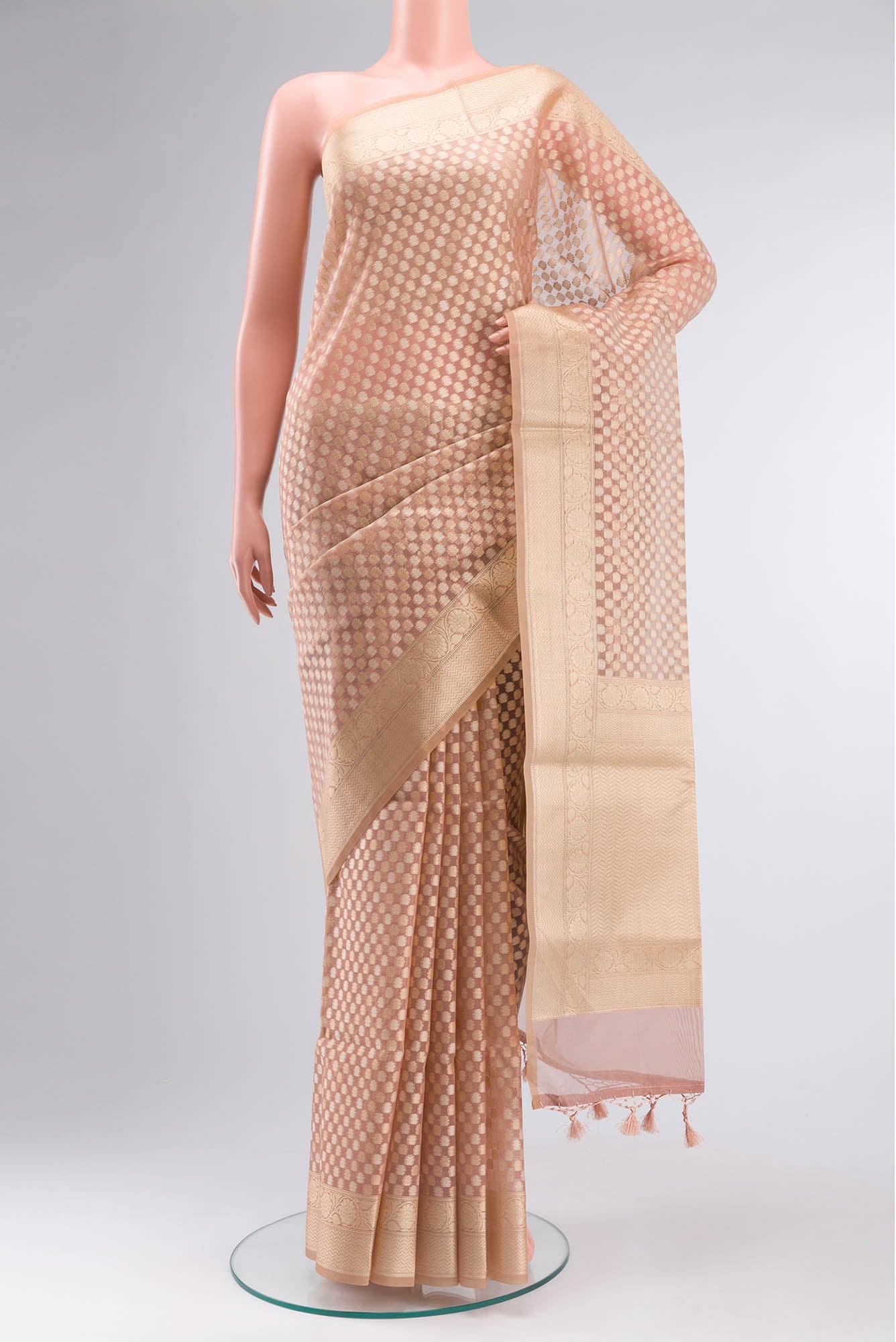 Rose Gold Blended Kora Cotton Saree with Zari And Thread Butta on the body and Zari Border.  displayed on a mannequin