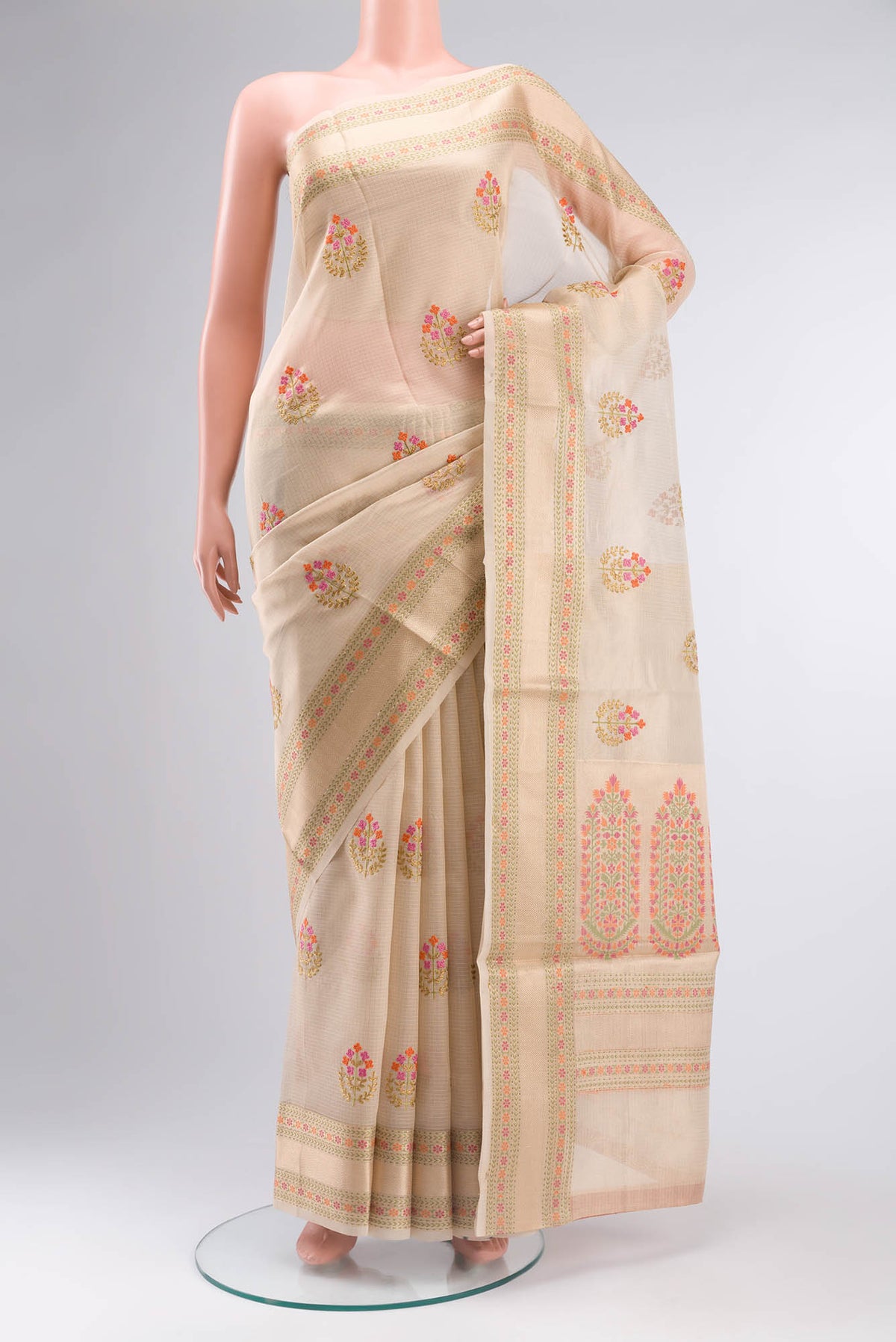 Gold Blended Kota Cotton Saree with Embroidery on the body and Zari And Thread Border.  displayed on a mannequin