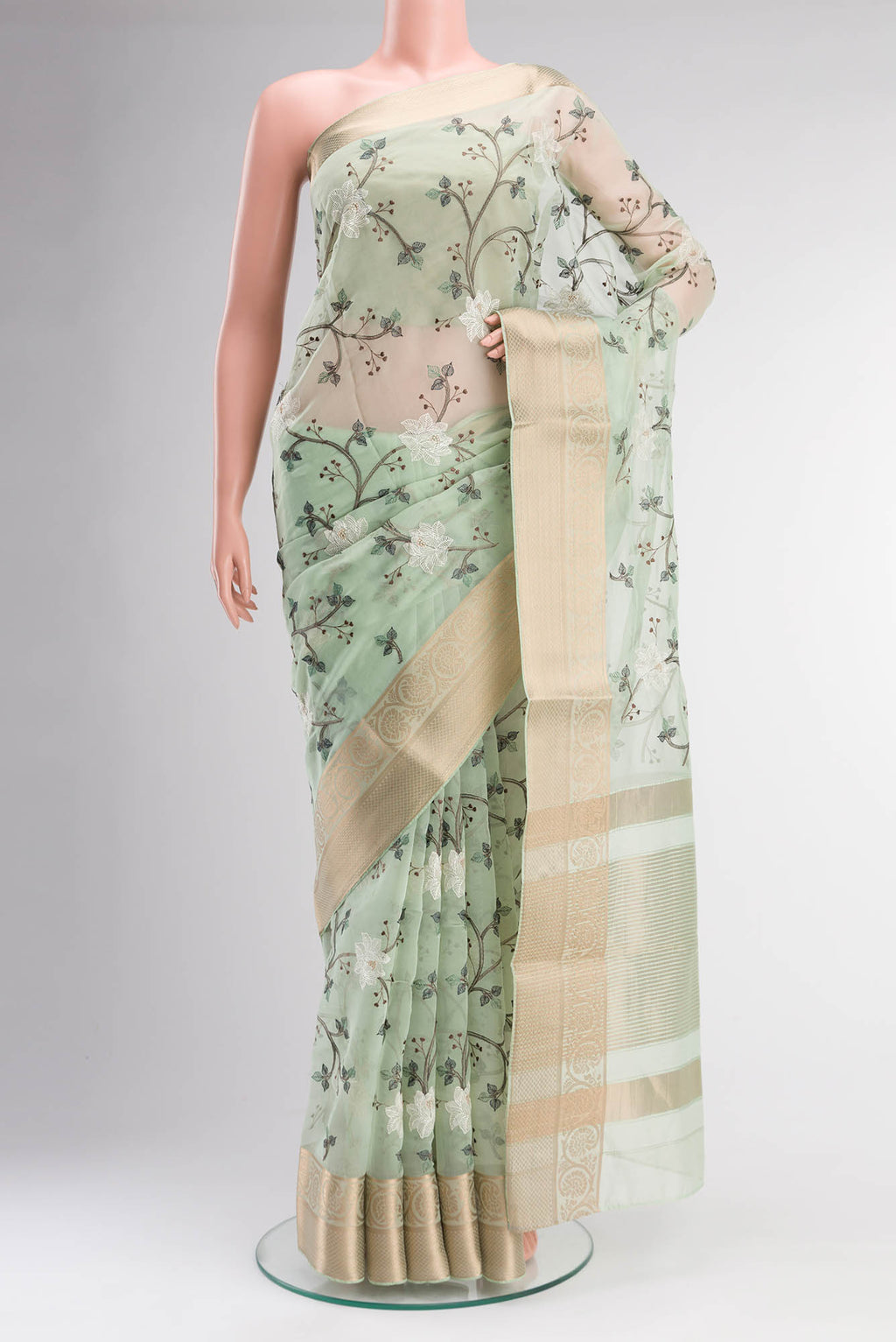 Green Blended Organza Silk Saree with Embroidery on the body and Zari Border.  displayed on a mannequin