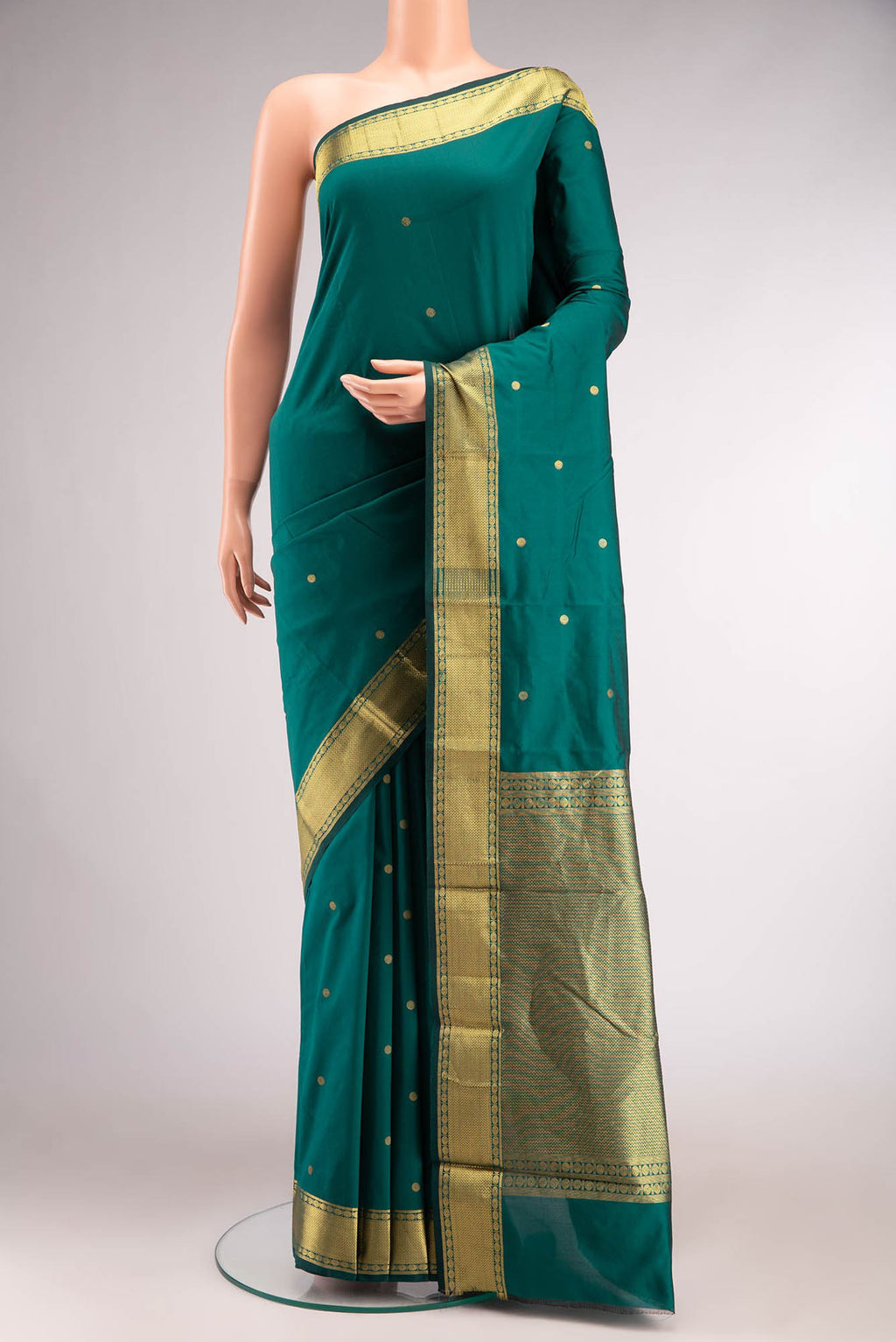 Green Blended Bangalore Silk Saree with Zari Butta on the body and Zari Border.  displayed on a mannequin