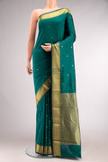 Green Blended Bangalore Silk Saree with Zari Butta on the body and Zari Border.  displayed on a mannequin