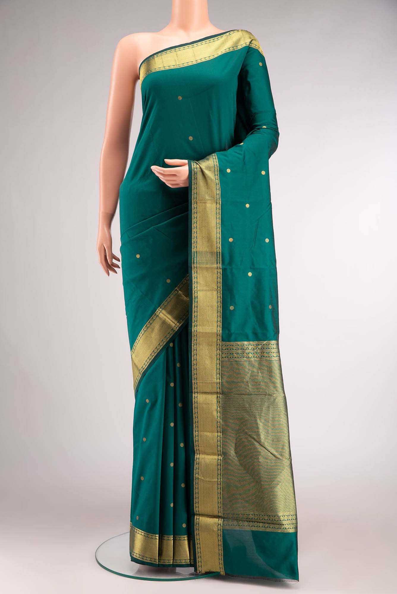 Green Blended Bangalore Silk Saree with Zari Butta on the body and Zari Border.  displayed on a mannequin