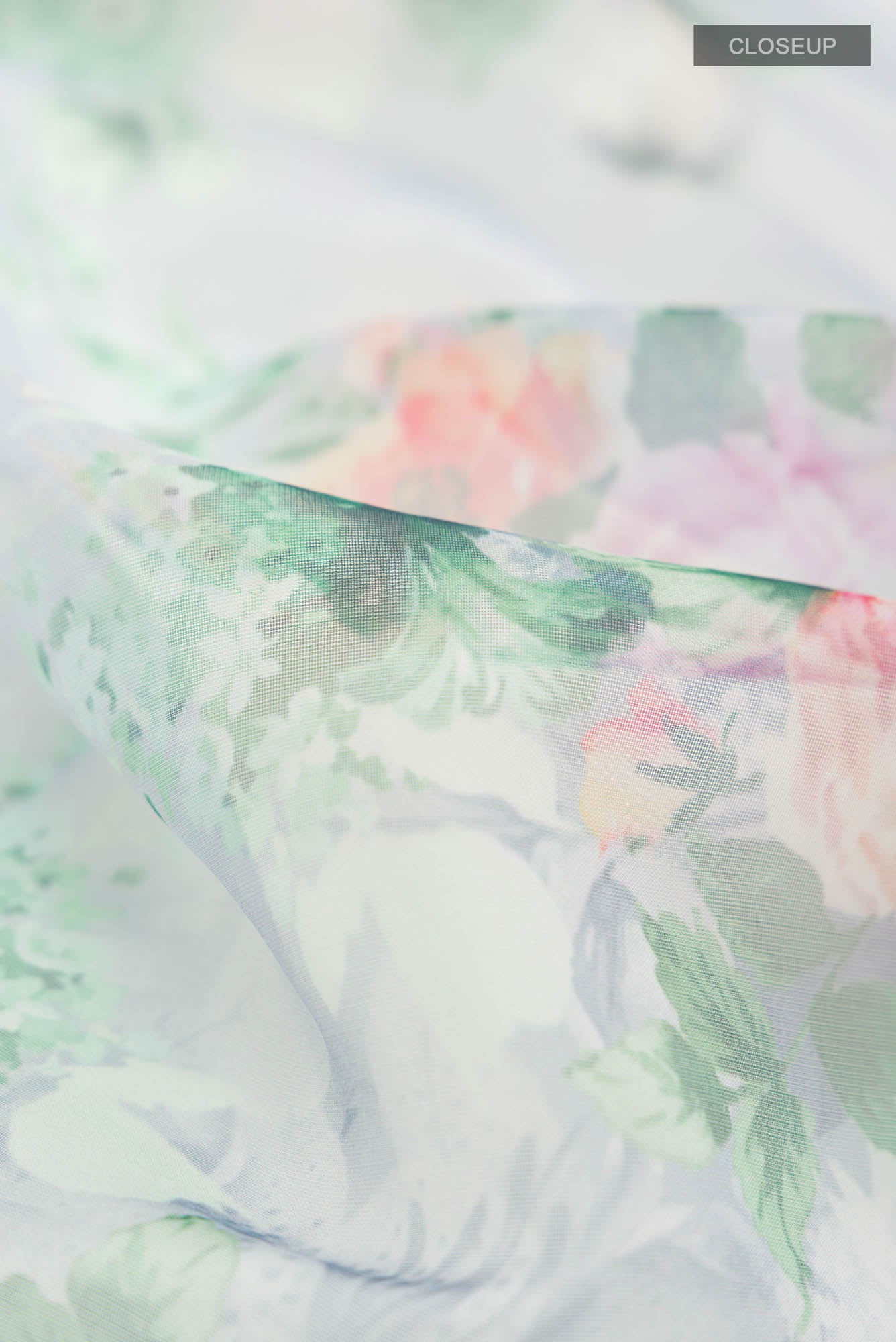 Close up of Grey Blended Organza Silk Saree with Floral Print on the body and Zari Border.  displaying folds