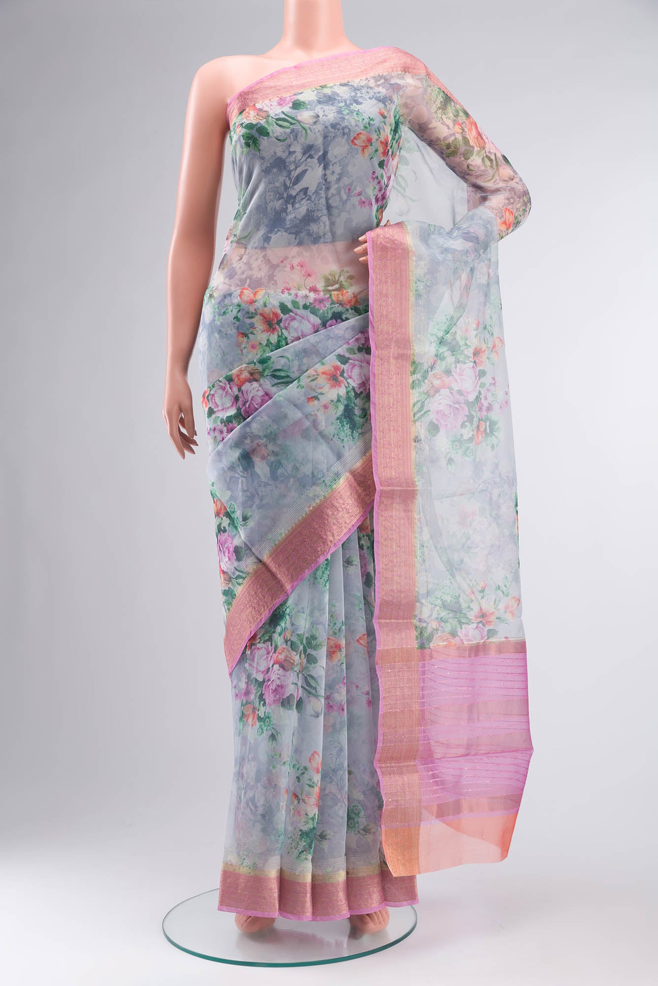 Grey Blended Organza Silk Saree with Floral Print on the body and Zari Border.  displayed on a mannequin
