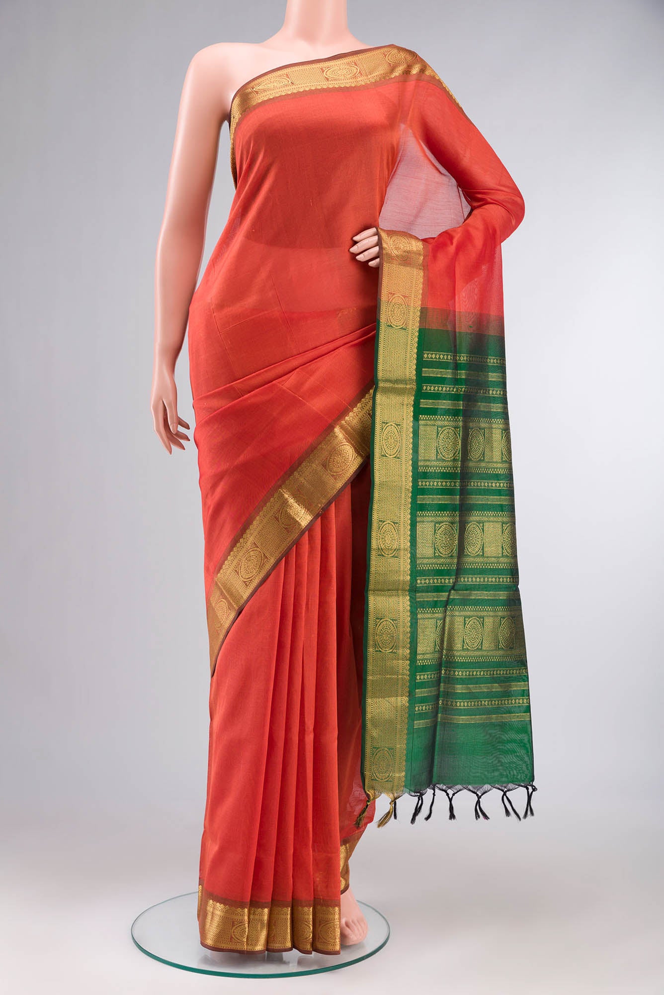Orange Silk Cotton Saree with Plain Body and Zari Border.  displayed on a mannequin