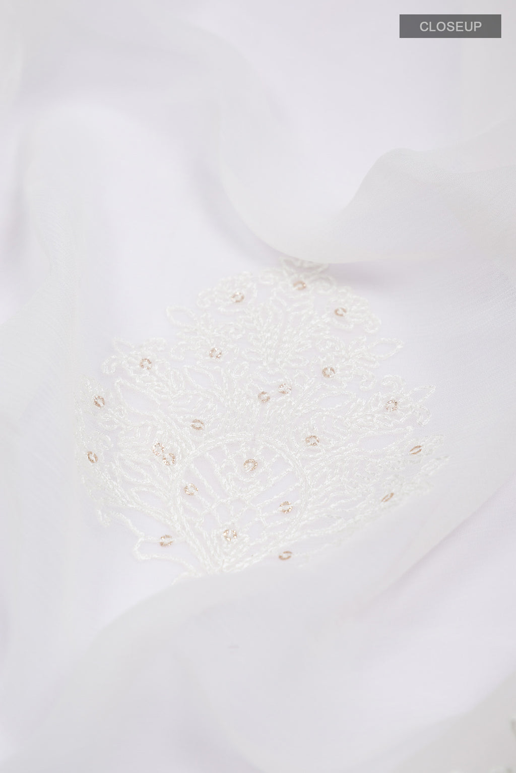 Close up of White Blended Chiffon Saree with Embroidery on the body and Embroidery Border.  displaying folds