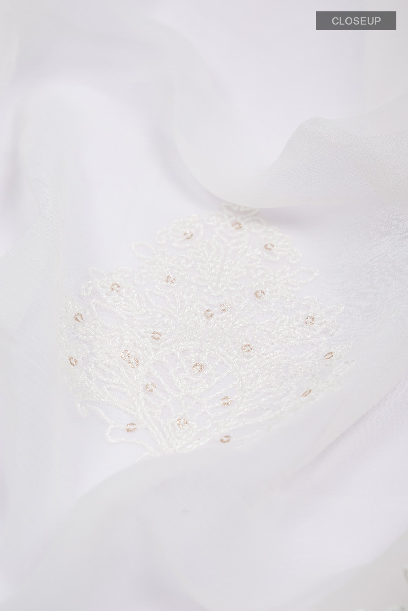 Close up of White Blended Chiffon Saree with Embroidery on the body and Embroidery Border.  displaying folds
