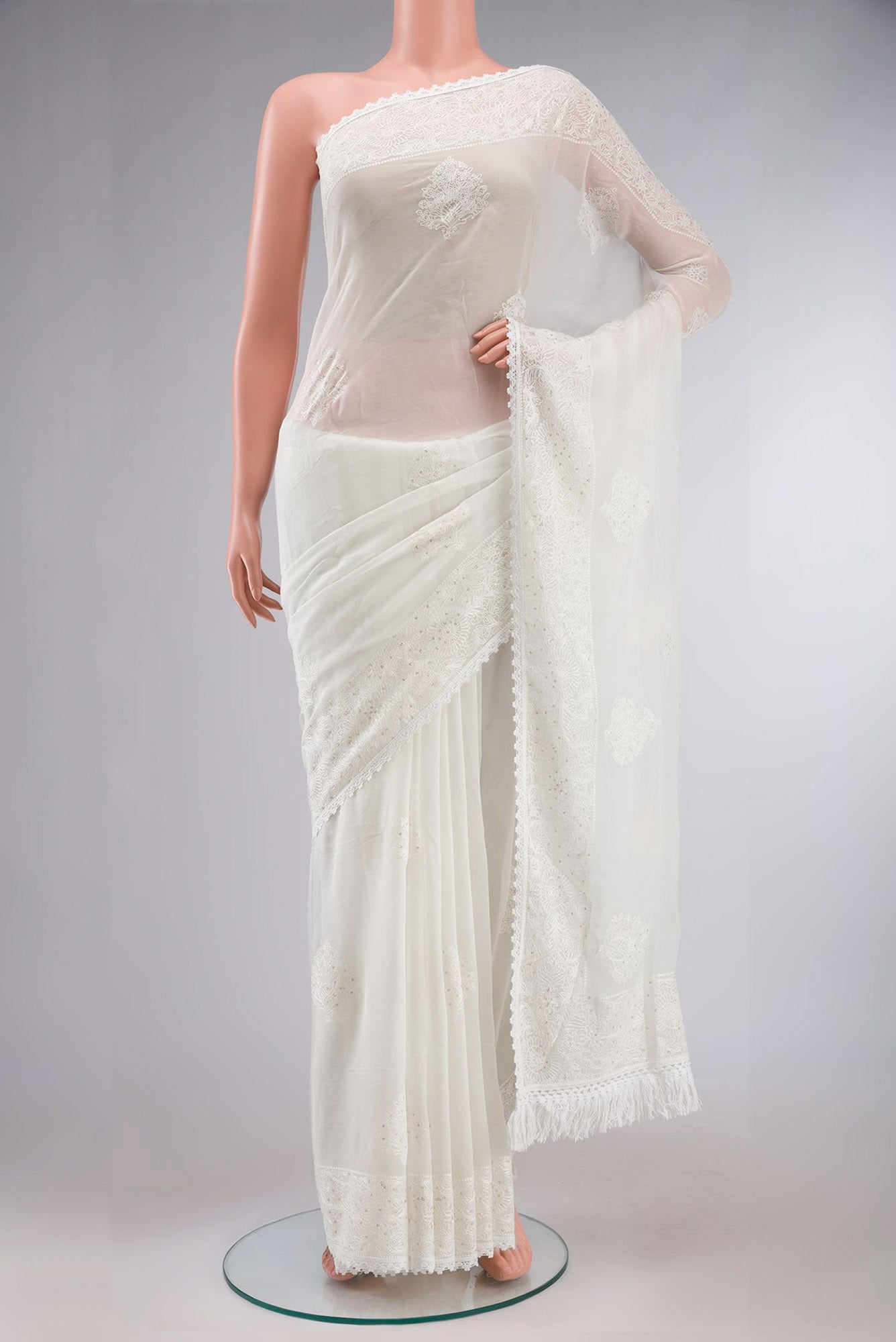 White Blended Chiffon Saree with Embroidery on the body and Embroidery Border.  displayed on a mannequin