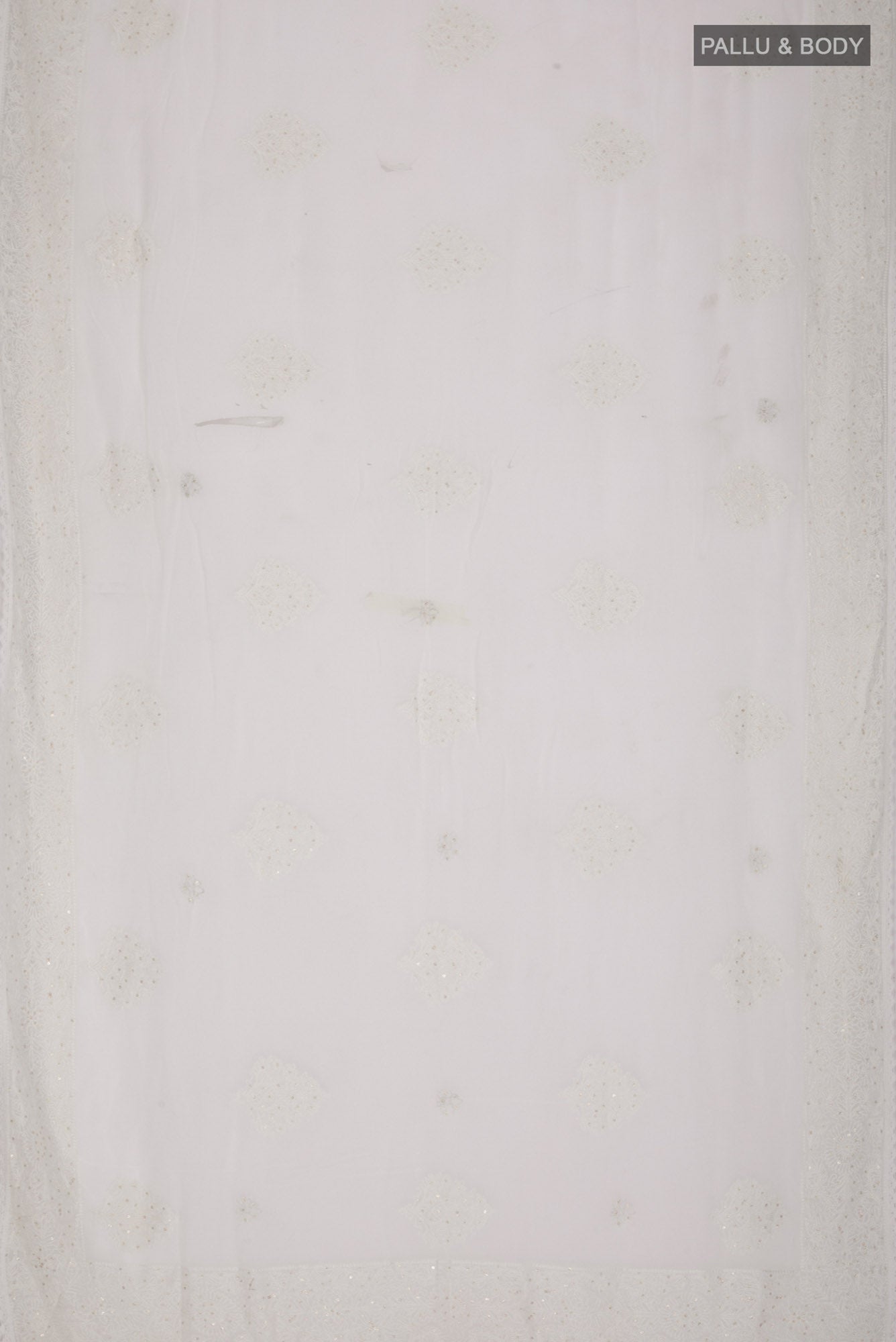 Flat view of White Blended Chiffon Saree with Embroidery on the body and Embroidery Border. 
