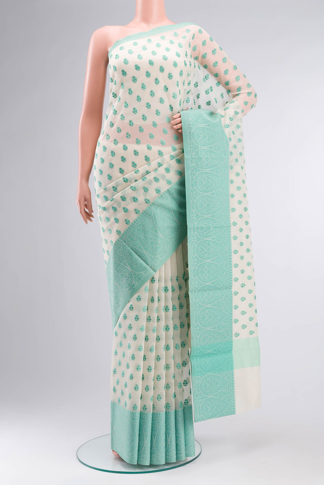 Cream Blended Kota Cotton Saree with Embroidery on the body and Thread Border.  displayed on a mannequin