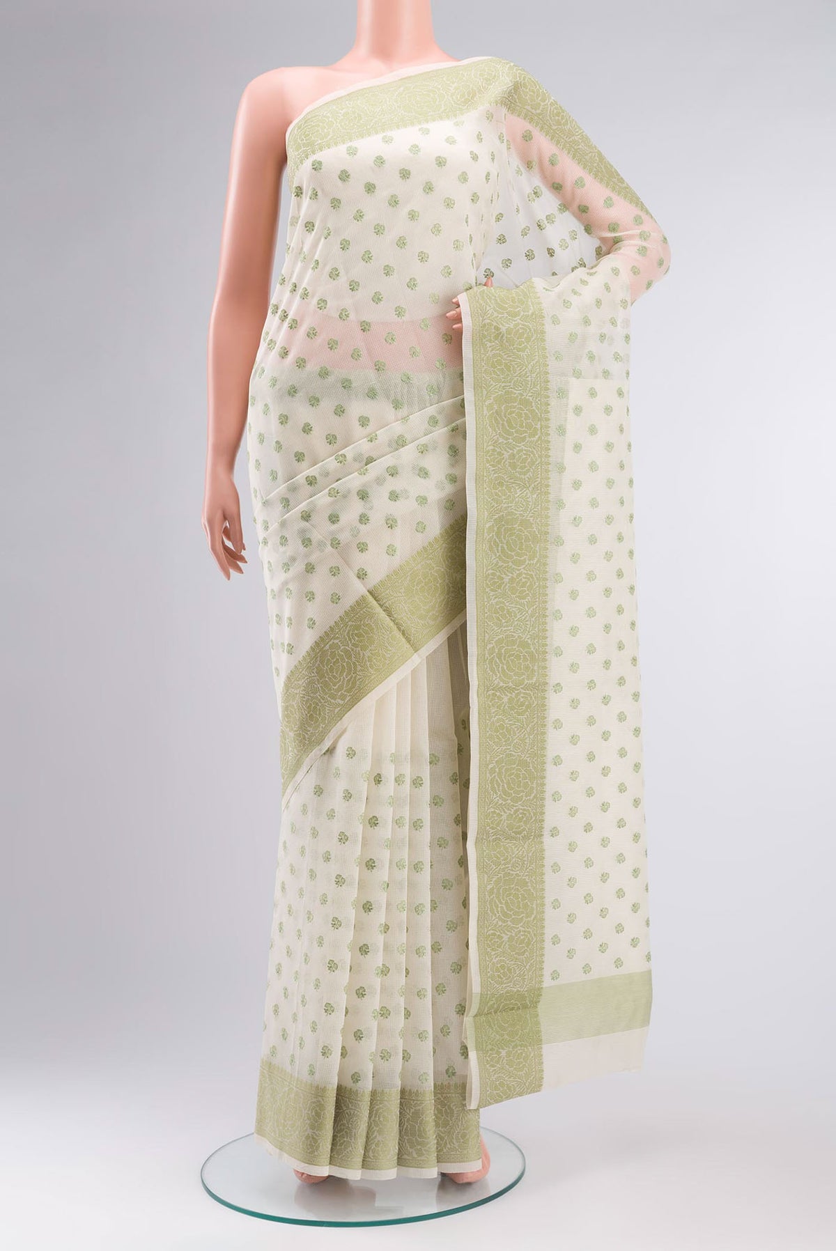 Cream Blended Kota Cotton Saree with Embroidery on the body and Thread Border.  displayed on a mannequin