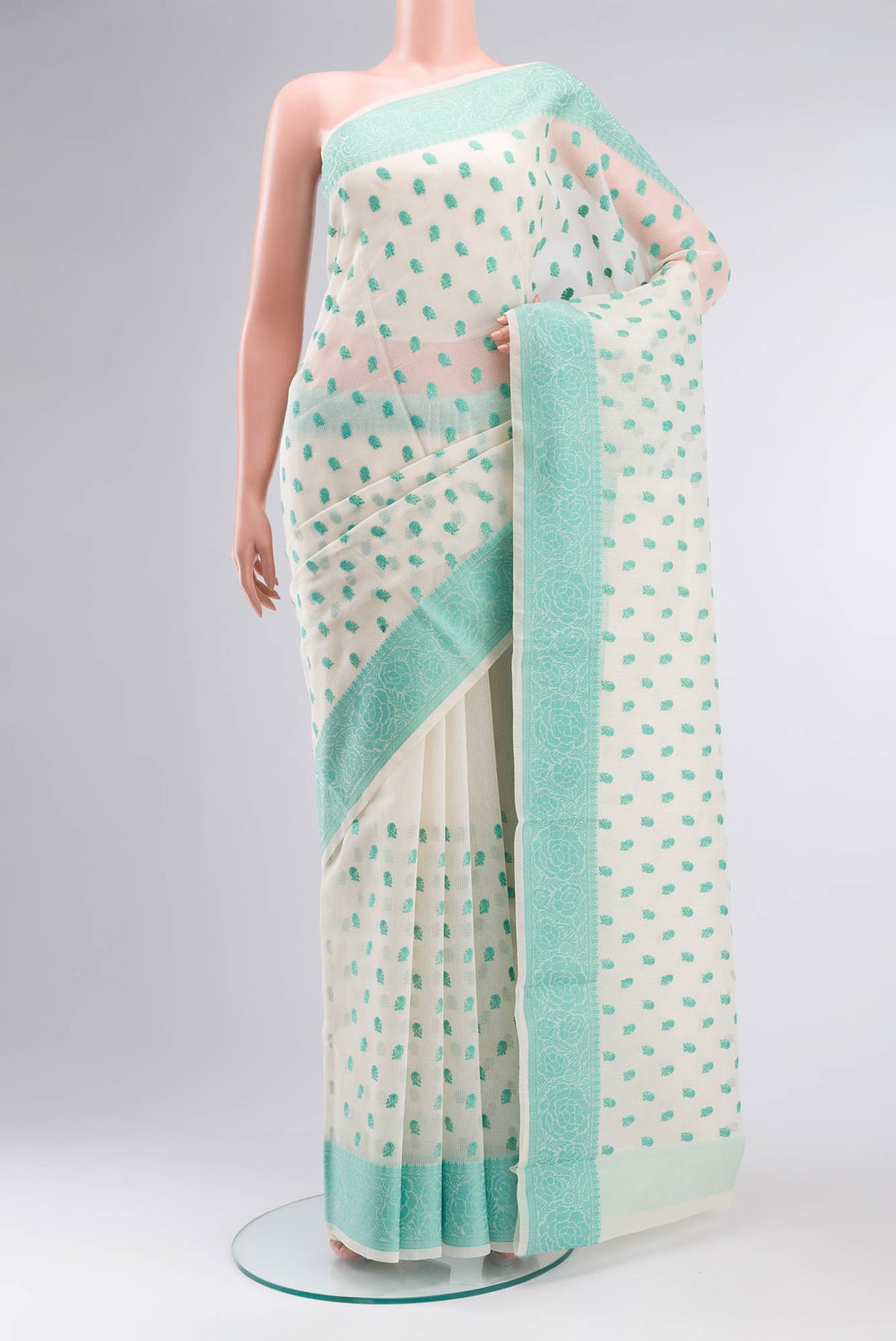 Cream Blended Kota Cotton Saree with Embroidery on the body and Thread Border.  displayed on a mannequin