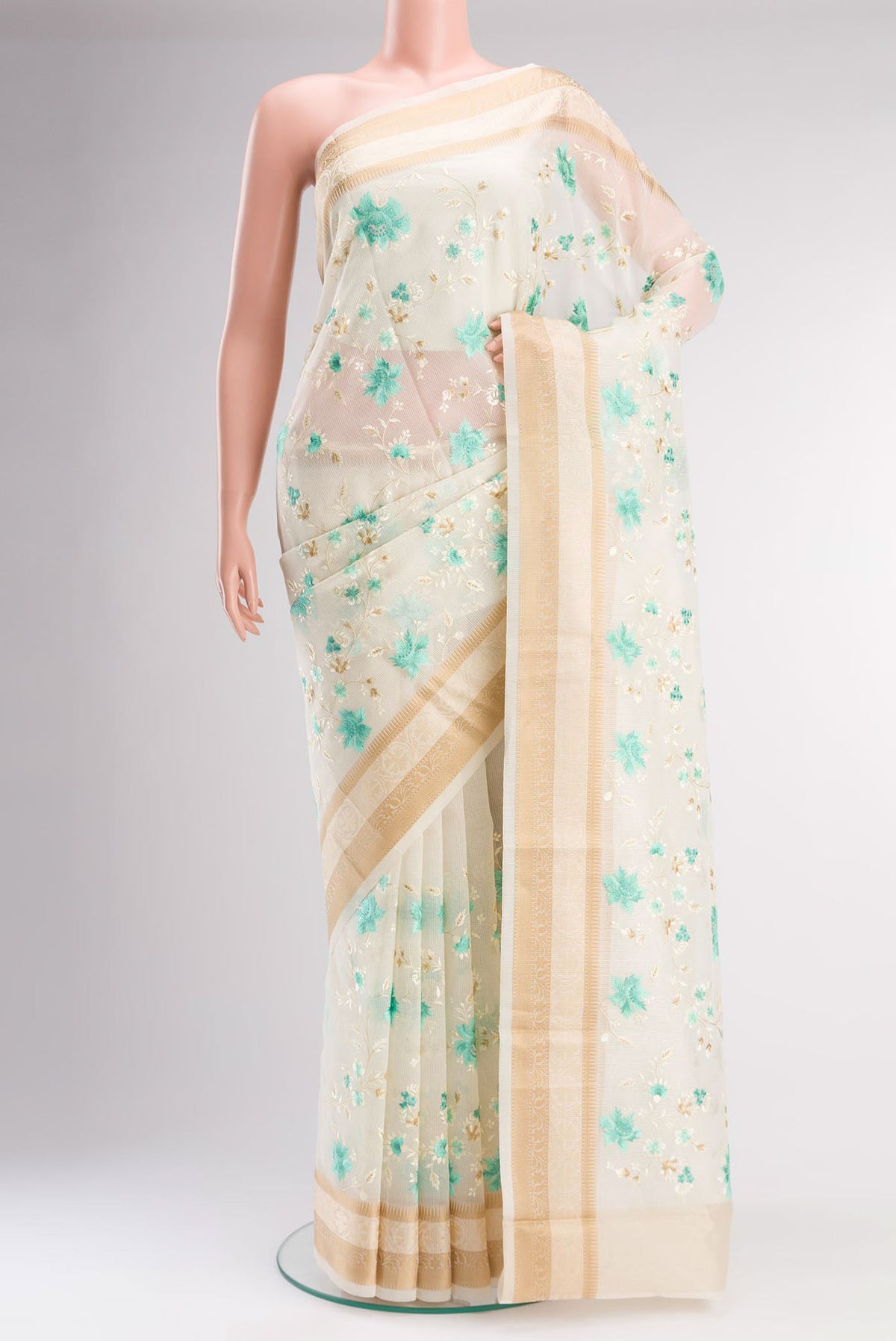 Cream Blended Kota Cotton Saree with Embroidery on the body and Thread Border.  displayed on a mannequin