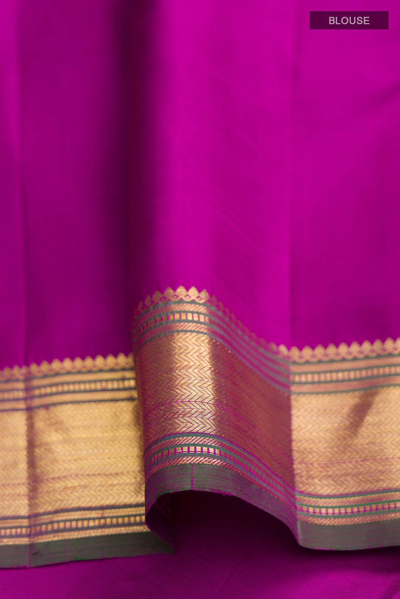 Close up image of the blouse of Green Kanchipuram Silk Saree with Plain Body and Zari Border. 