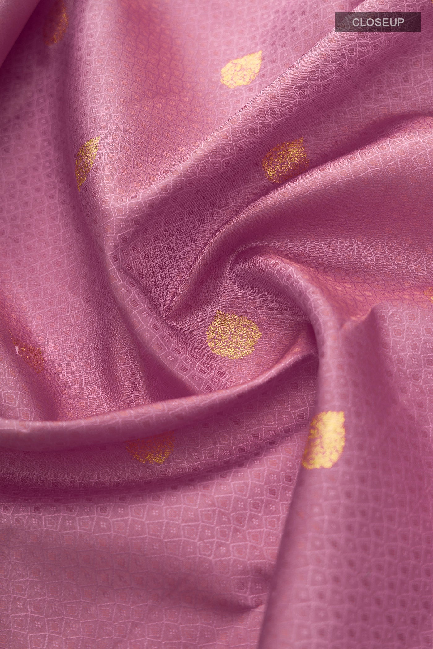 Close up of Pink Kanjivaram Silk Saree with Jacquard With Zari Butta on the body and Zari Border.  displaying folds