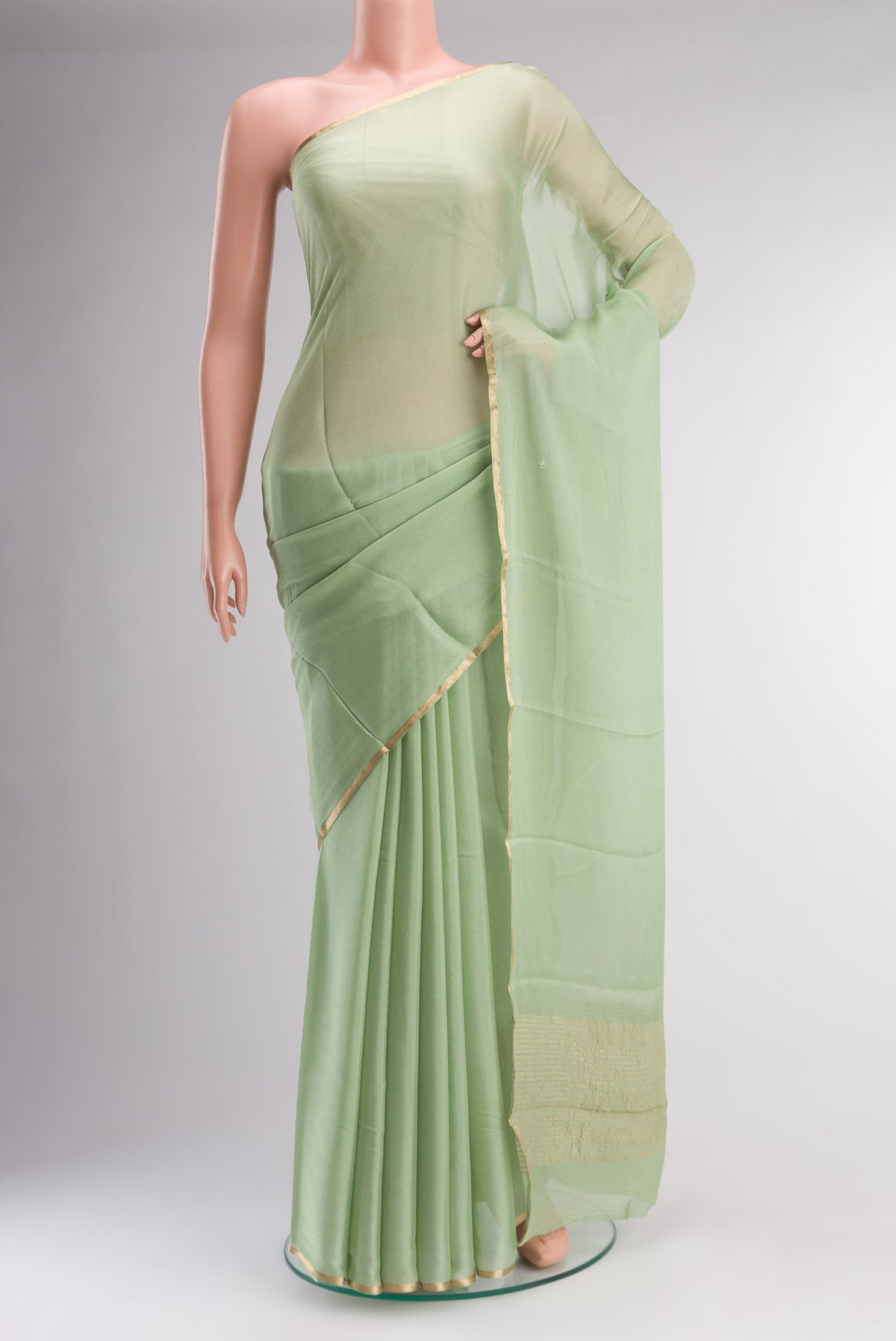 Green Mysore Chiffon Saree with Plain Body and Zari Border.  displayed on a mannequin