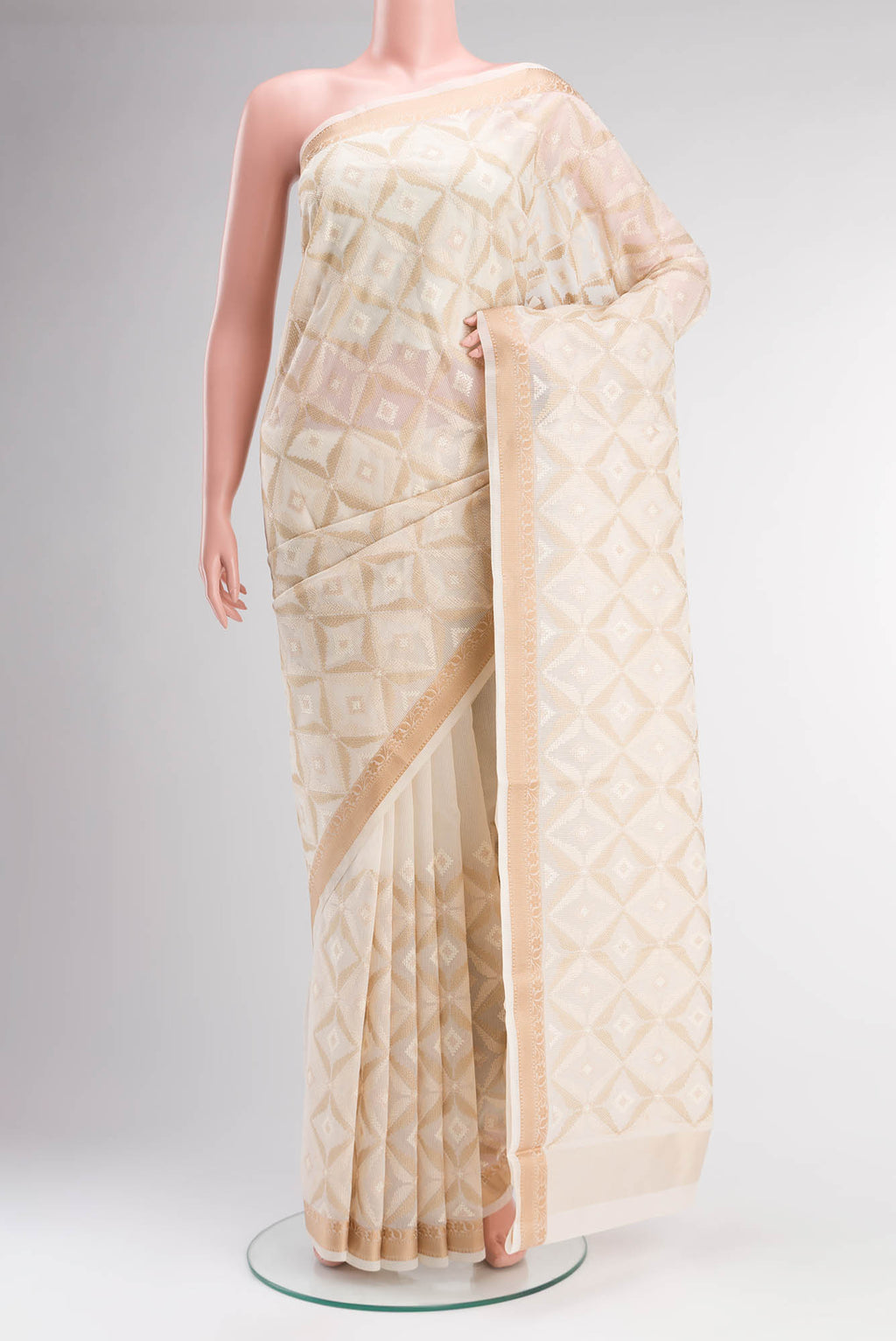 Cream Blended Kota Cotton Saree with Embroidery on the body and Thread Border.  displayed on a mannequin