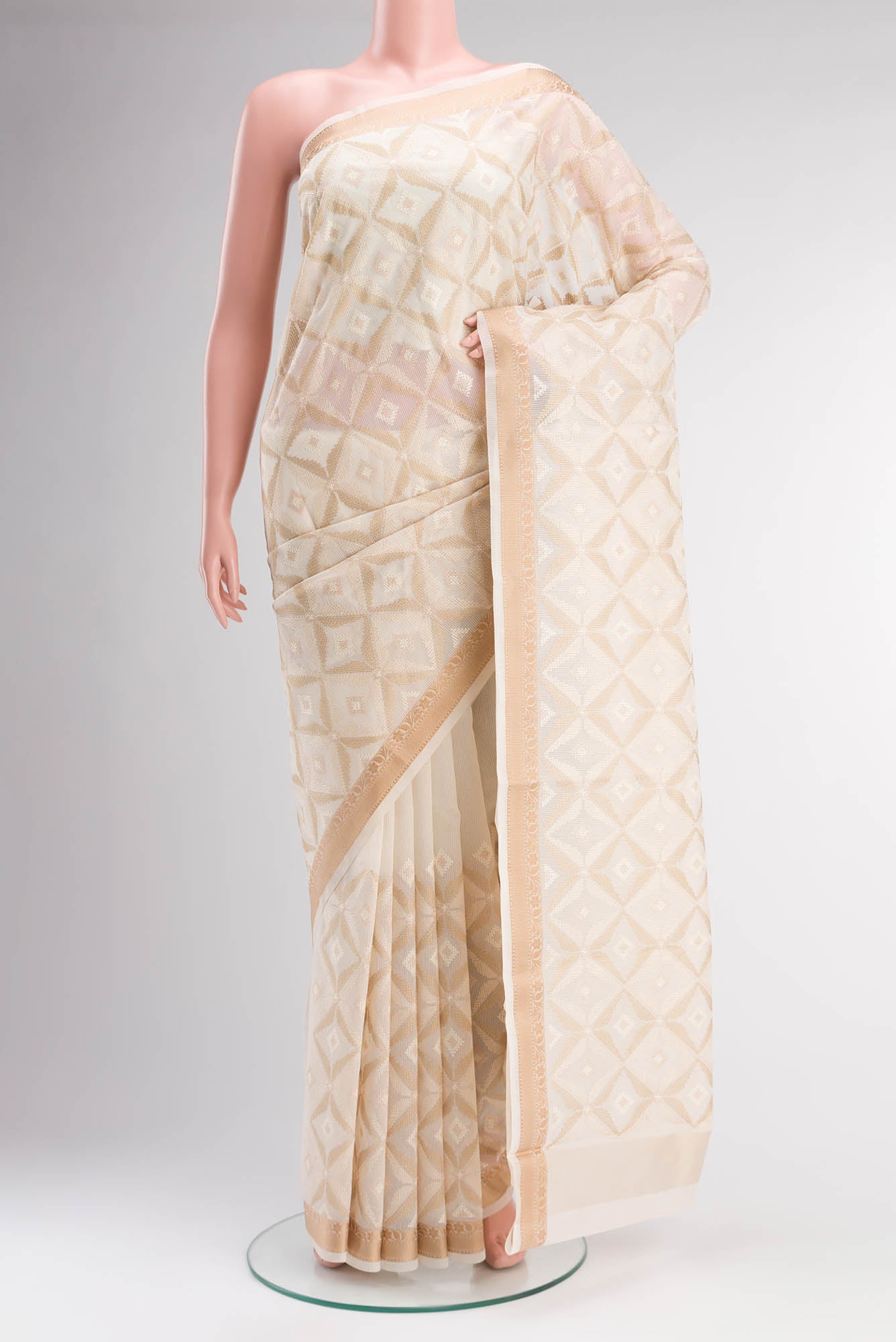 Cream Blended Kota Cotton Saree with Embroidery on the body and Thread Border.  displayed on a mannequin