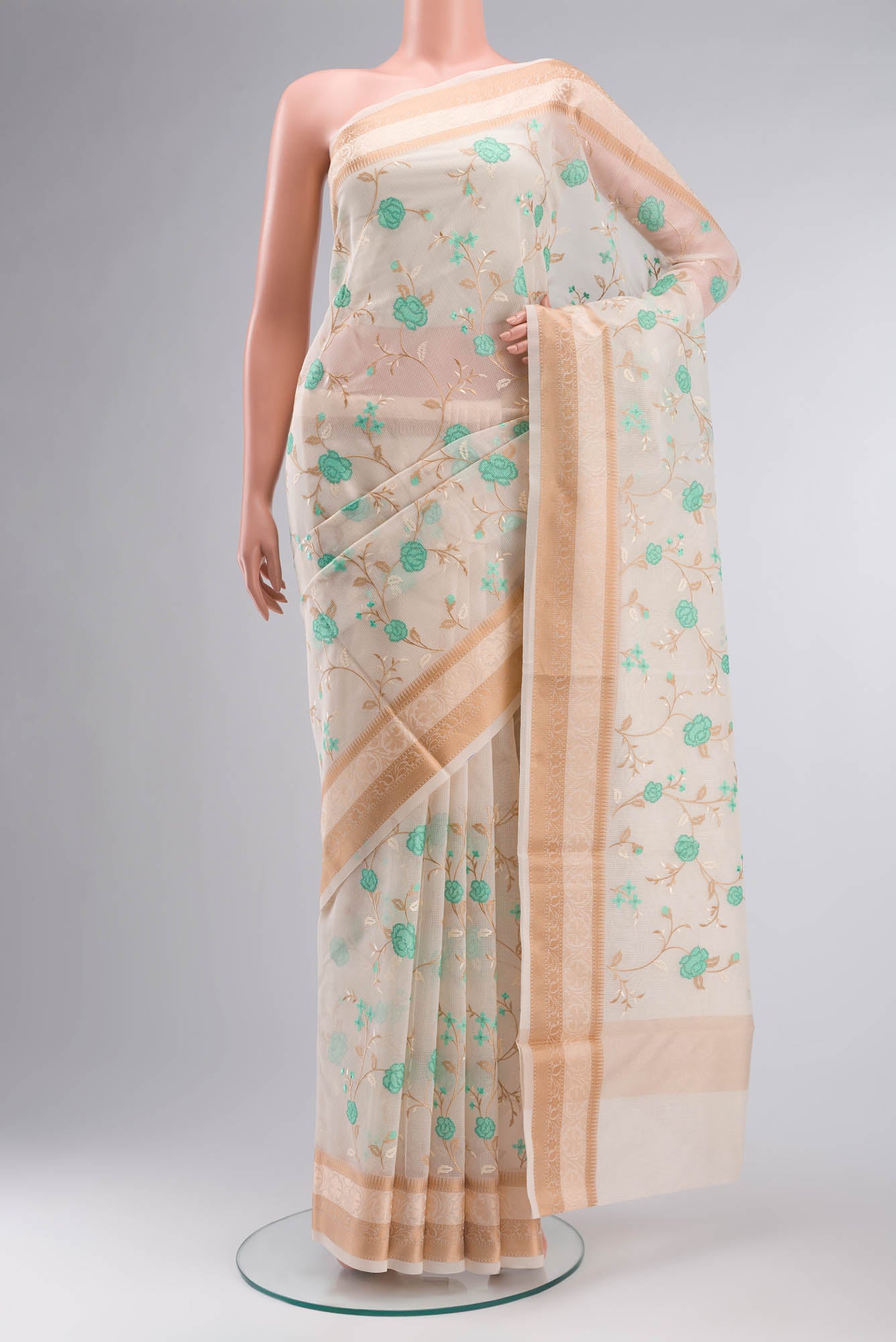 Cream Blended Kota Cotton Saree with Embroidery on the body and Thread Border.  displayed on a mannequin