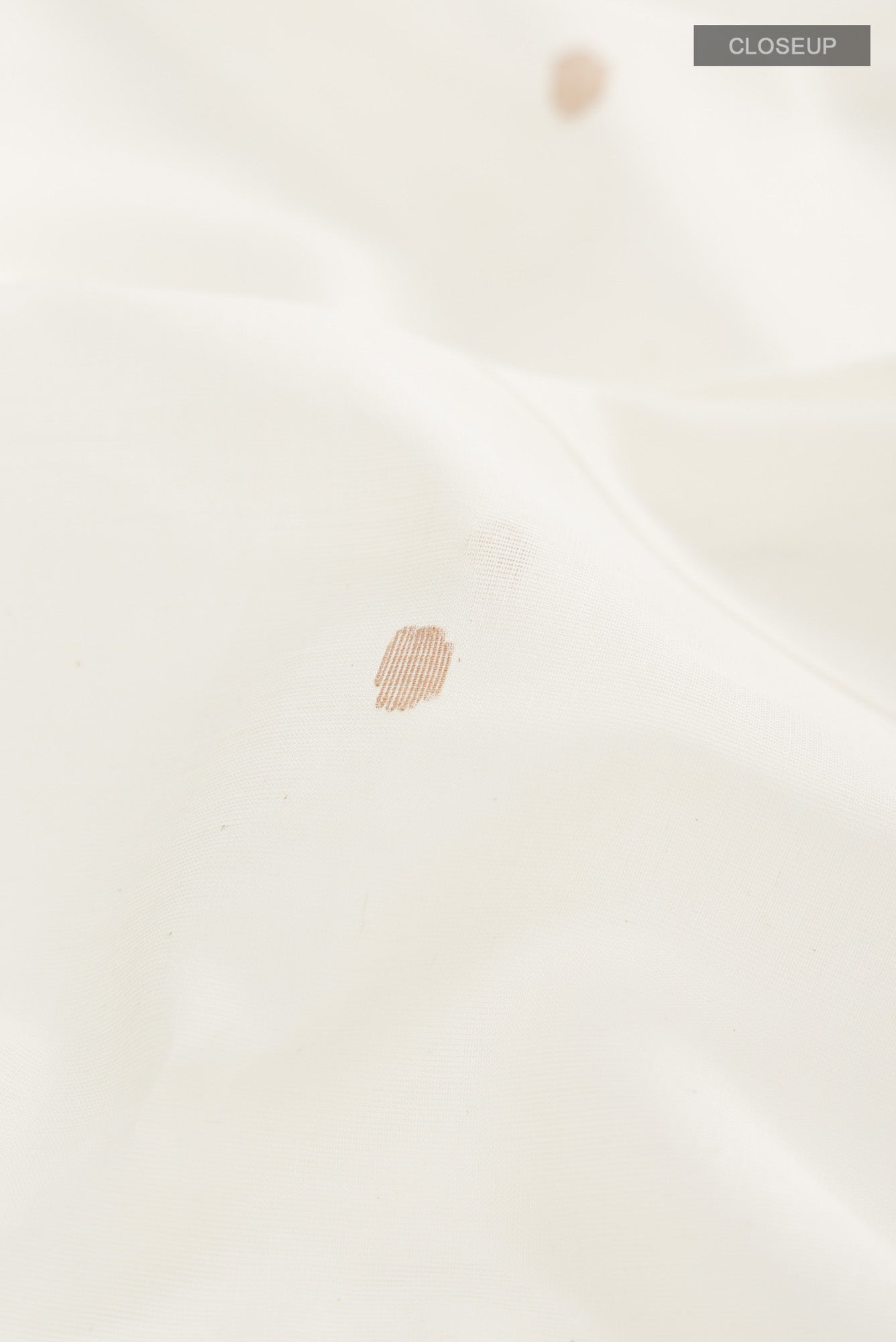 Close up of Off White Bengal Cotton Saree with Thread Butta on the body and Plain Border.  displaying folds