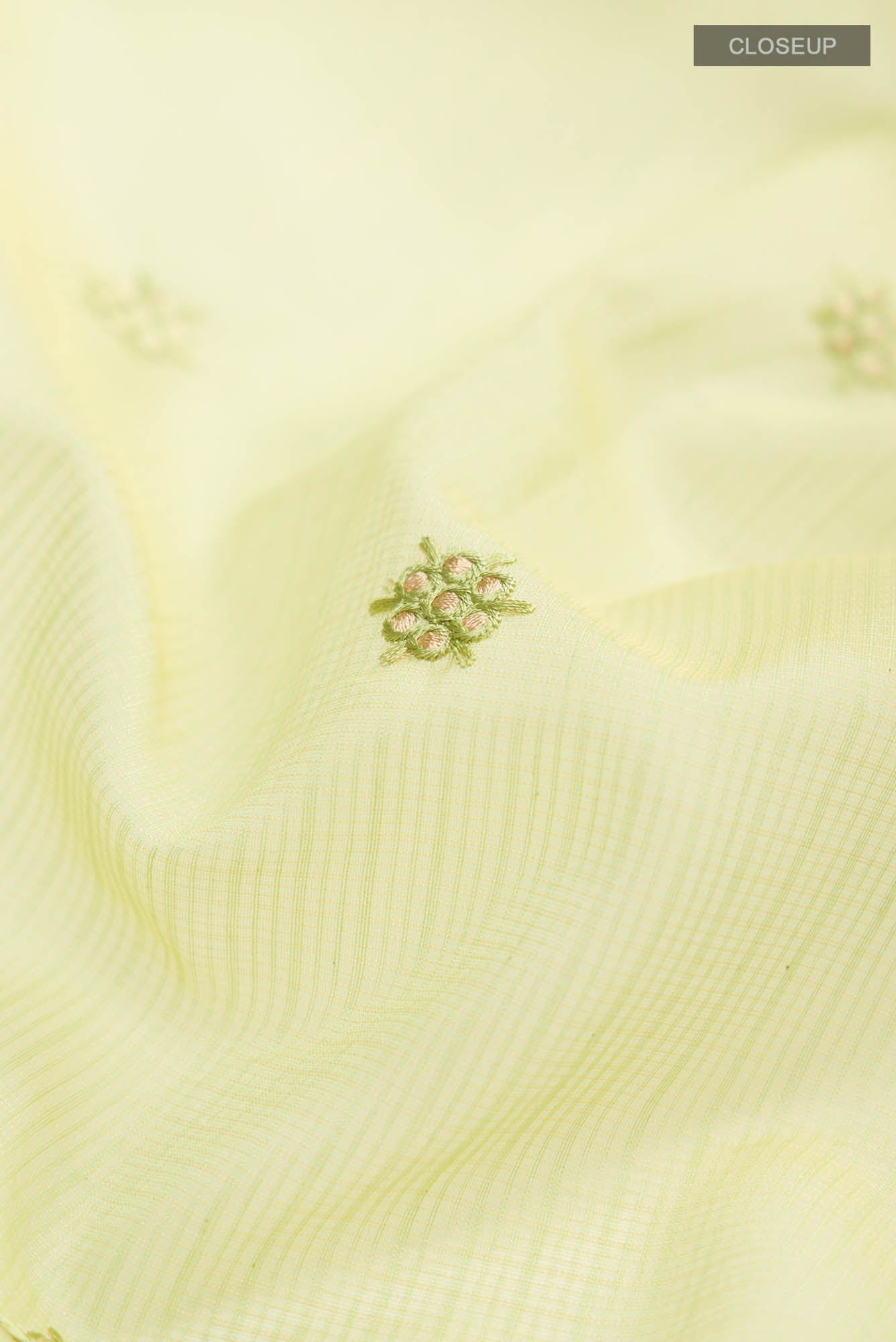 Close up of Green Blended Kota Cotton Saree with Embroidery on the body and Zari Border.  displaying folds