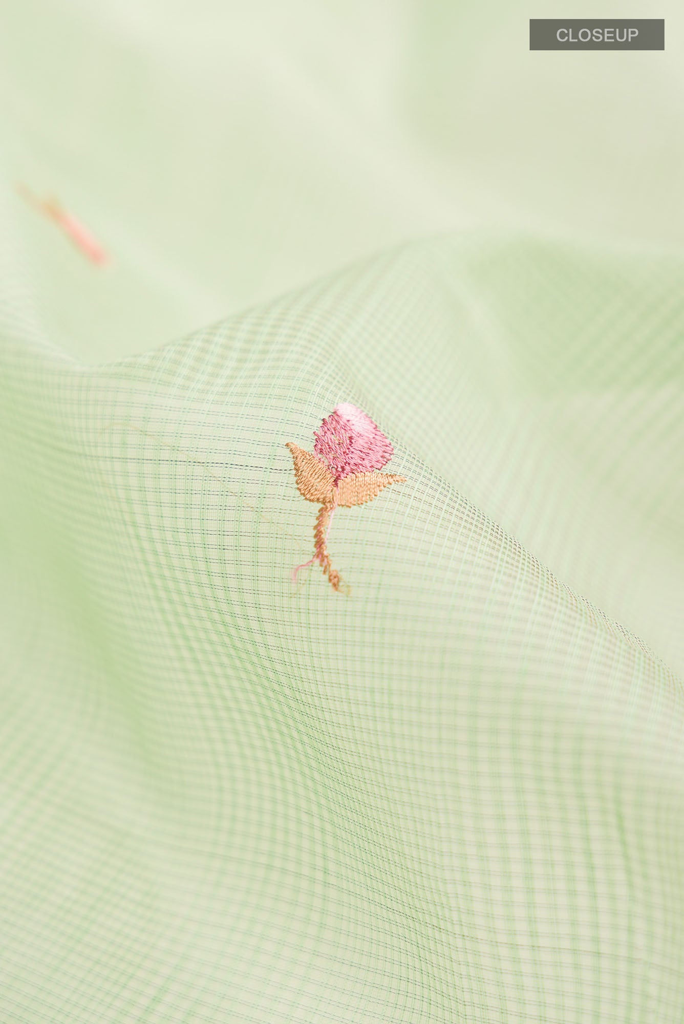 Close up of Green Blended Kota Cotton Saree with Embroidery on the body and Zari Border.  displaying folds