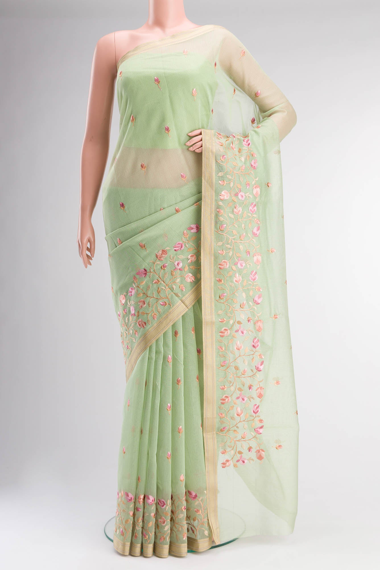 Green Blended Kota Cotton Saree with Embroidery on the body and Zari Border.  displayed on a mannequin