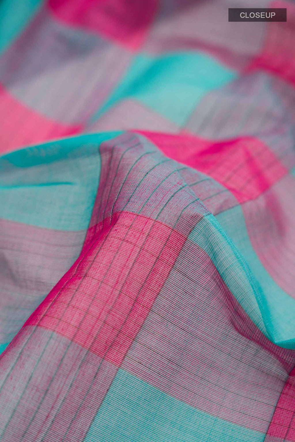 Close up of Multi Color Coimbatore Cotton Saree with Checked design on the body and Plain Border.  displaying folds