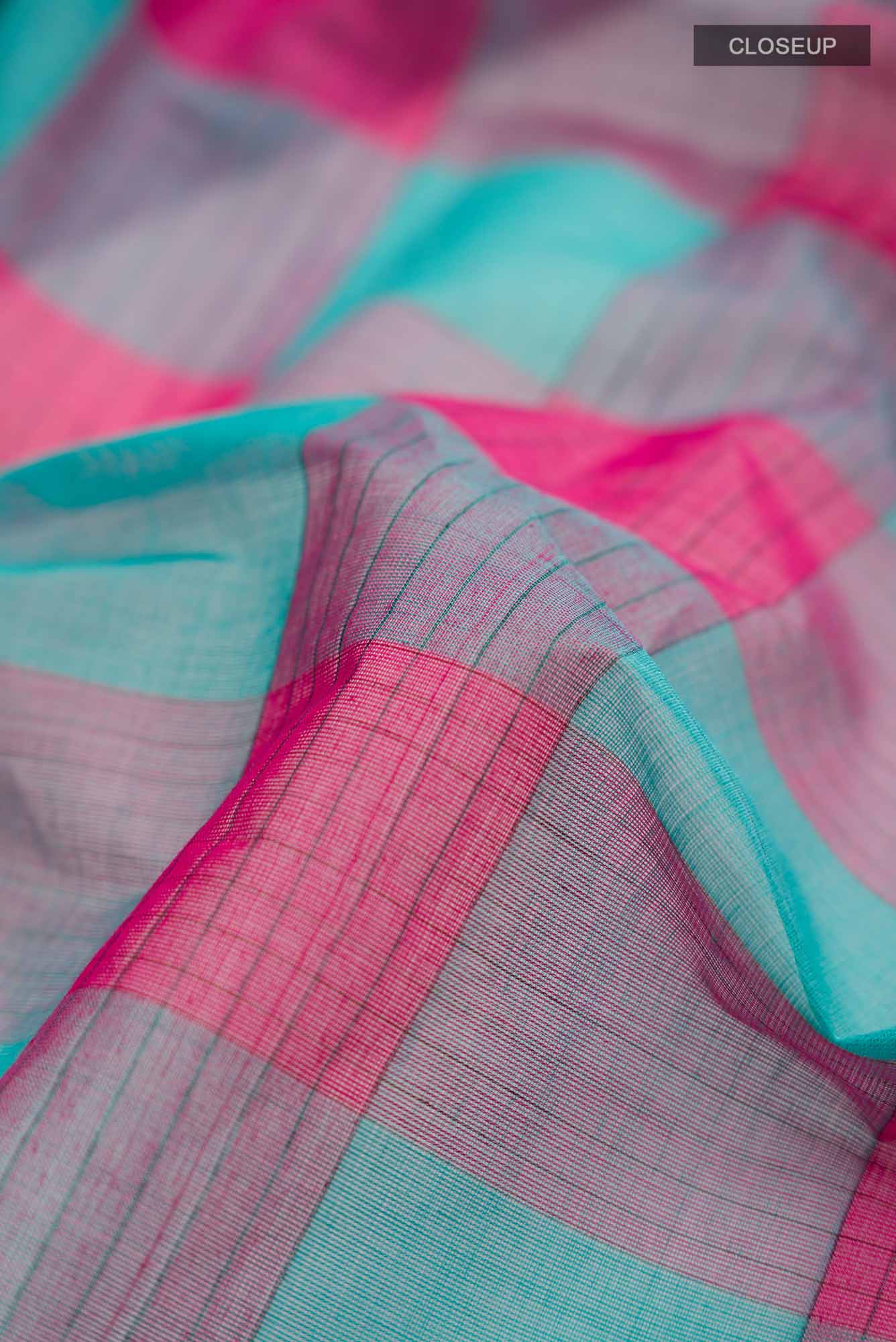 Close up of Multi Color Coimbatore Cotton Saree with Checked design on the body and Plain Border.  displaying folds
