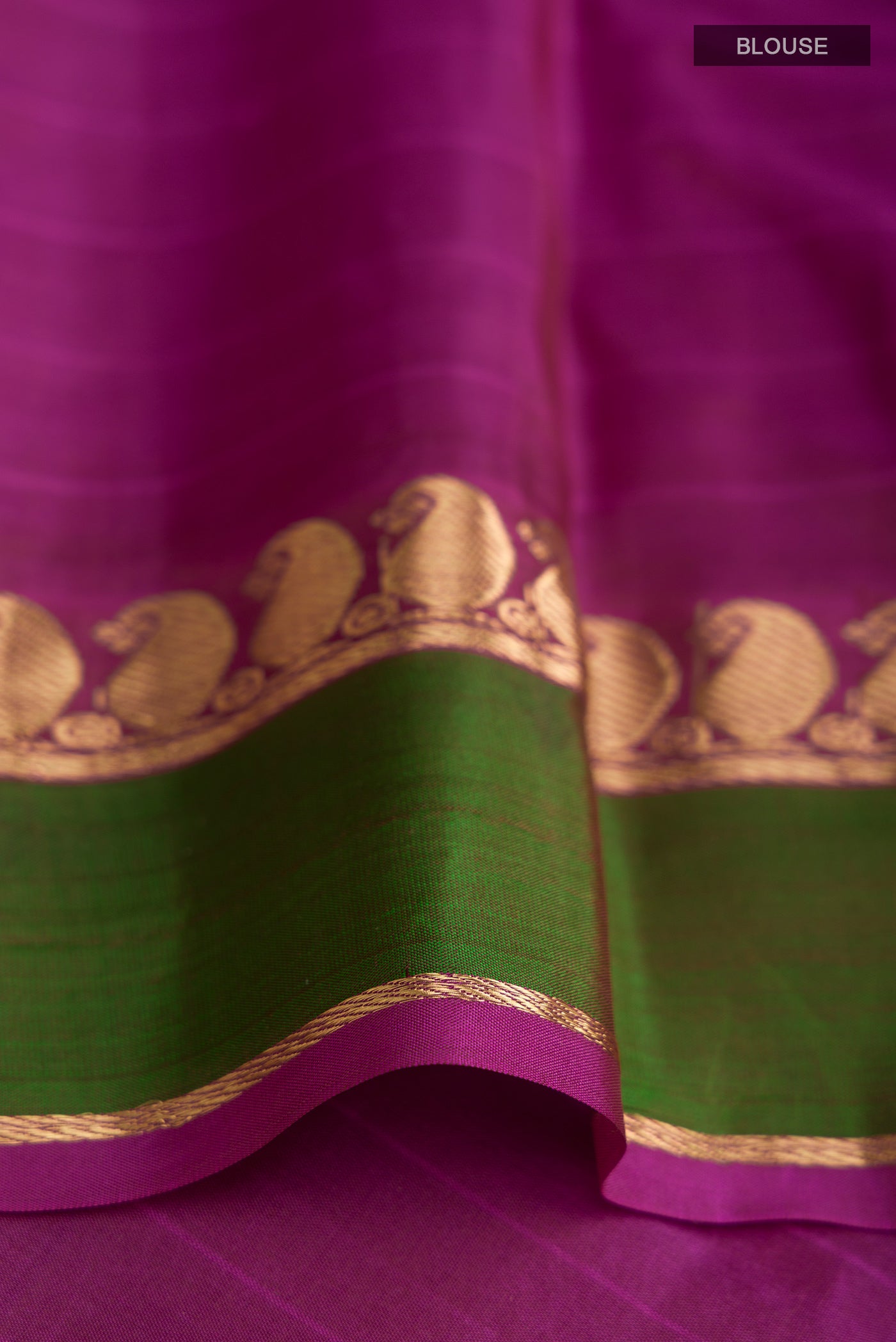 Close up image of the blouse of Orange Kanchipuram Silk Saree with Stripes on the body and Zari Border. 