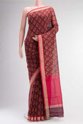 Maroon Silk Cotton Saree with Floral Print on the body and Zari Border.  displayed on a mannequin