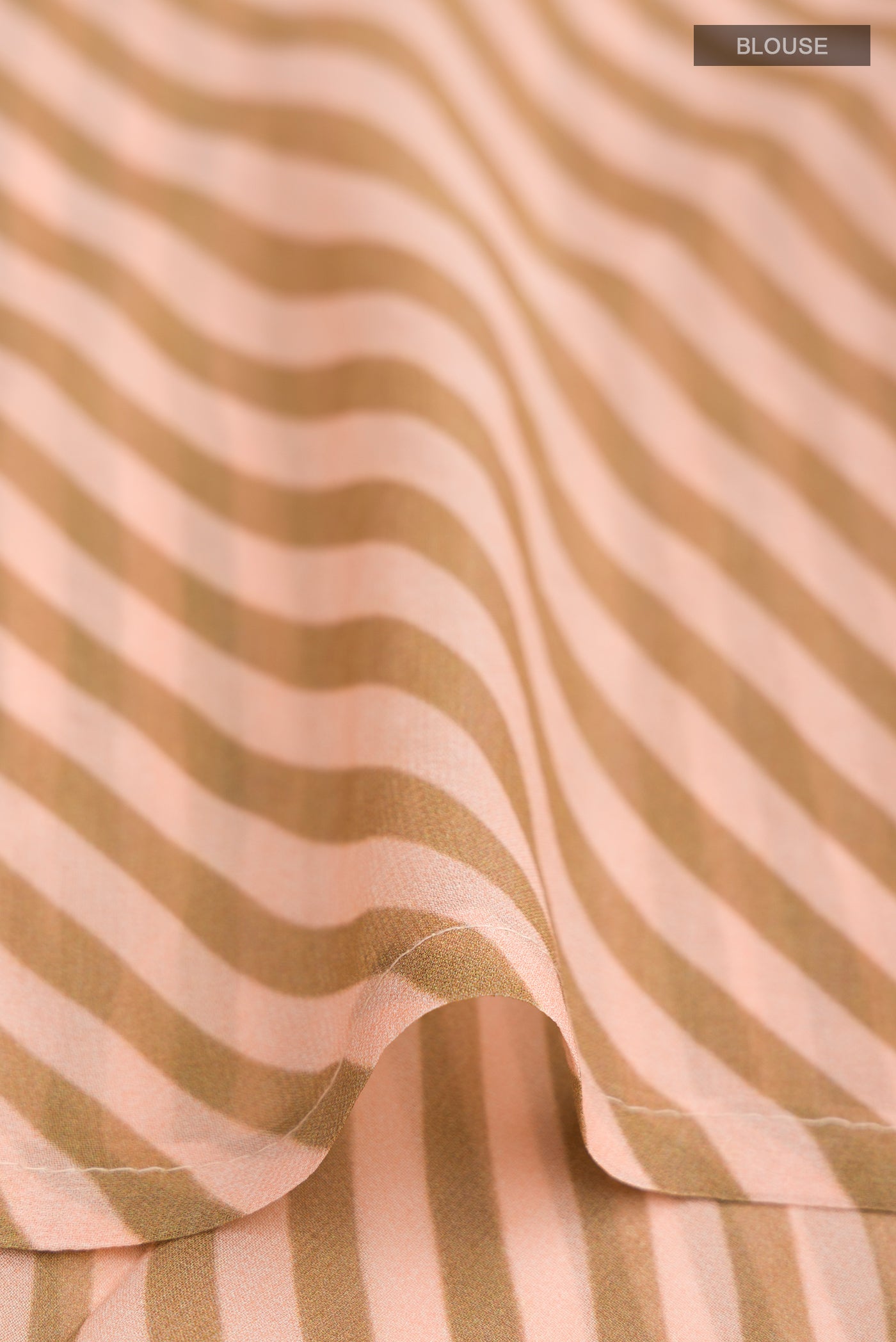 Close up image of the blouse of Peach Georgette Saree with Floral Print on the body and Embroidery Border. 