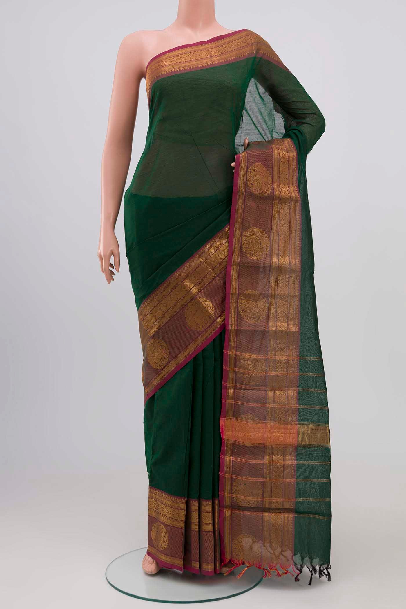 Green Kanchi Cotton Saree with Plain Body and Zari Border.  displayed on a mannequin