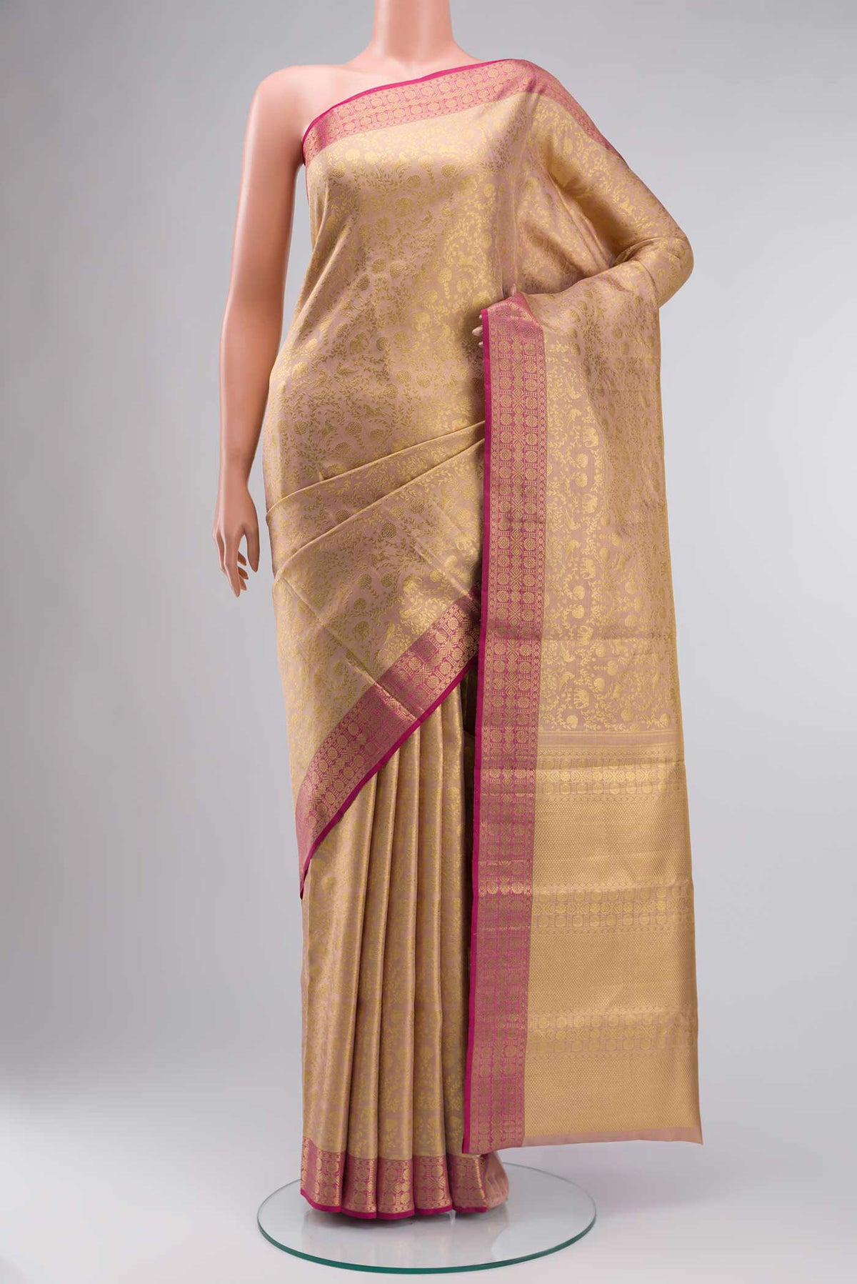 Rose Gold Kanchipuram Tissue Silk Saree with Zari Brocade on the body and Zari Border displayed on a mannequin