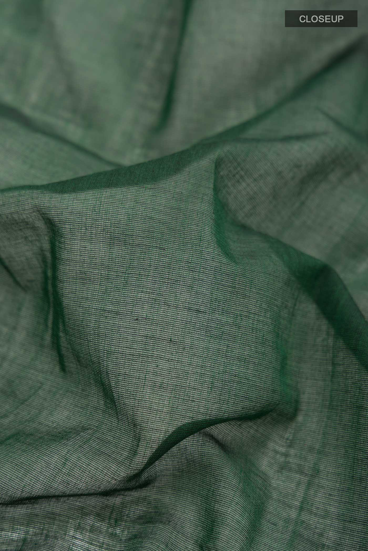 Close up of Bottle Green Dual Tone Bengal Cotton Saree with Plain Body and Zari Border displaying folds