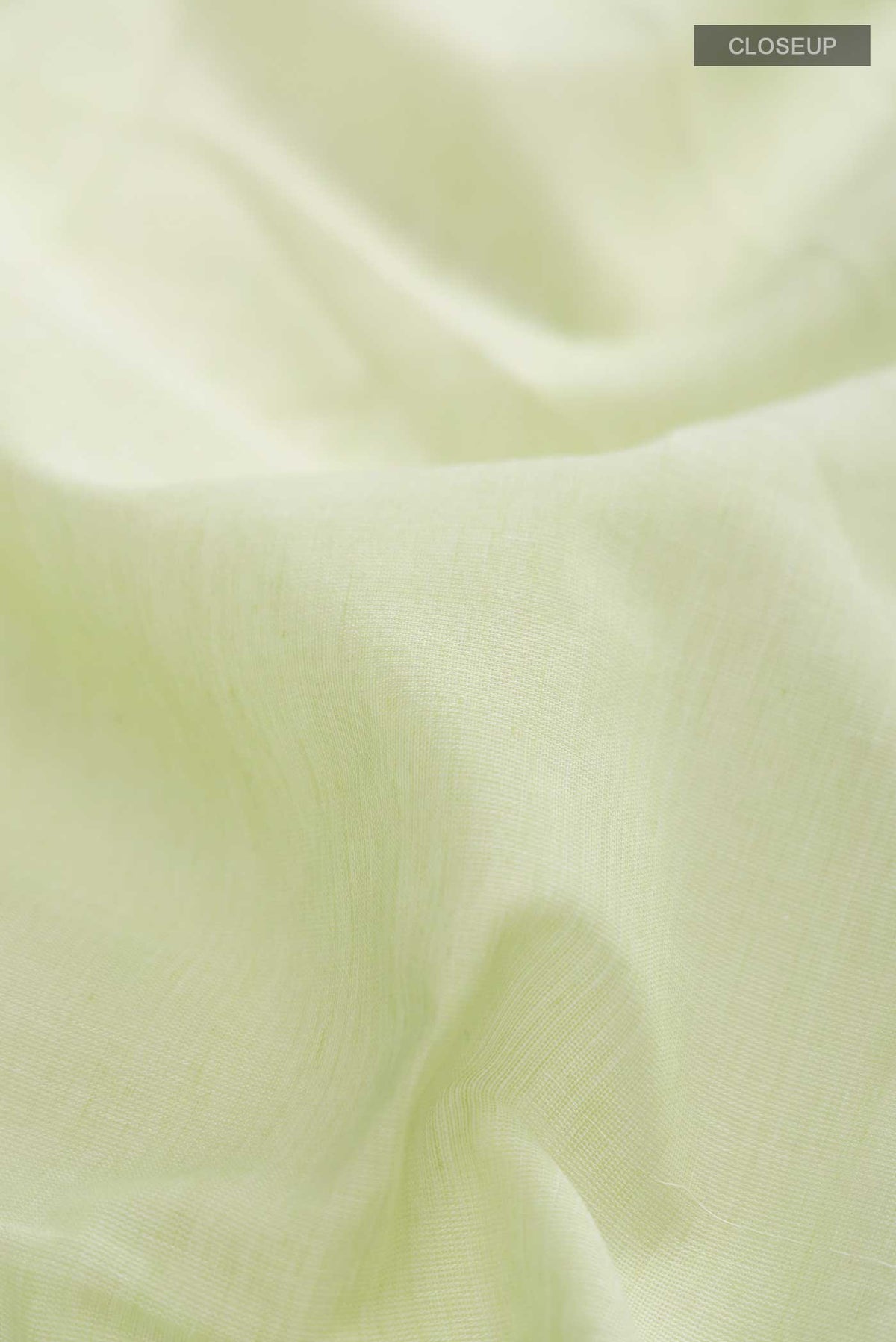 Close up of Light Green Bengal Cotton Saree with Plain Body and Zari Border displaying folds