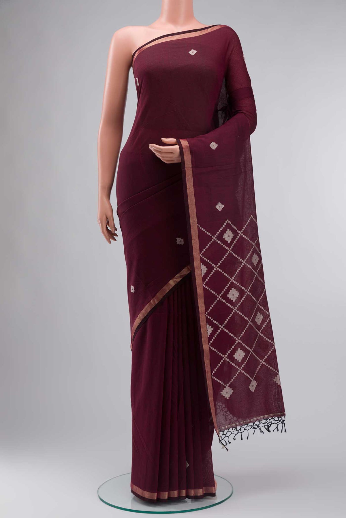 Maroon Bengal Cotton Saree with Plain Body and Zari Border displayed on a mannequin