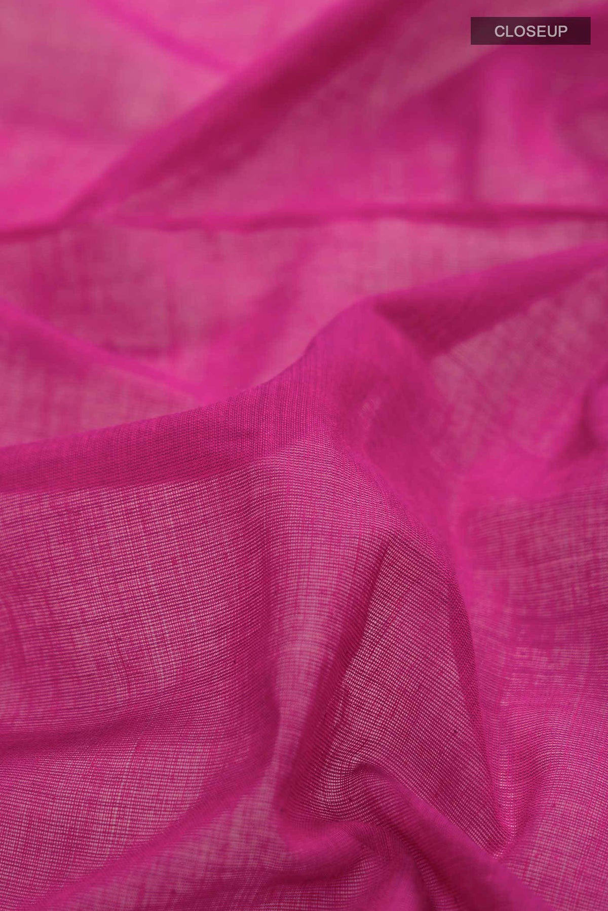 Close up of Magenta Bengal Cotton Saree with Plain Body and Zari Border displaying folds