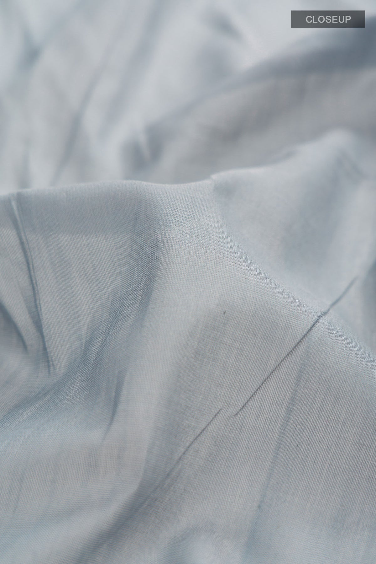 Close up of Grey Bengal Cotton Saree with Plain Body and Zari Border displaying folds