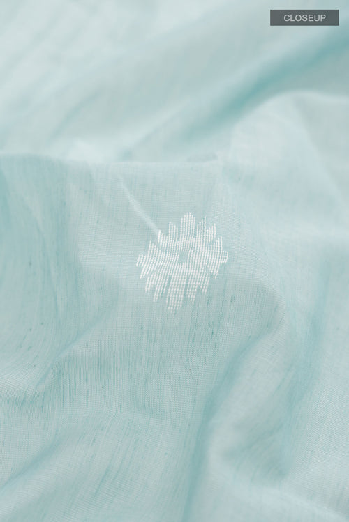 Close up of Sea Green Bengal Cotton Saree with Thread Butta on the body and Zari Border displaying folds